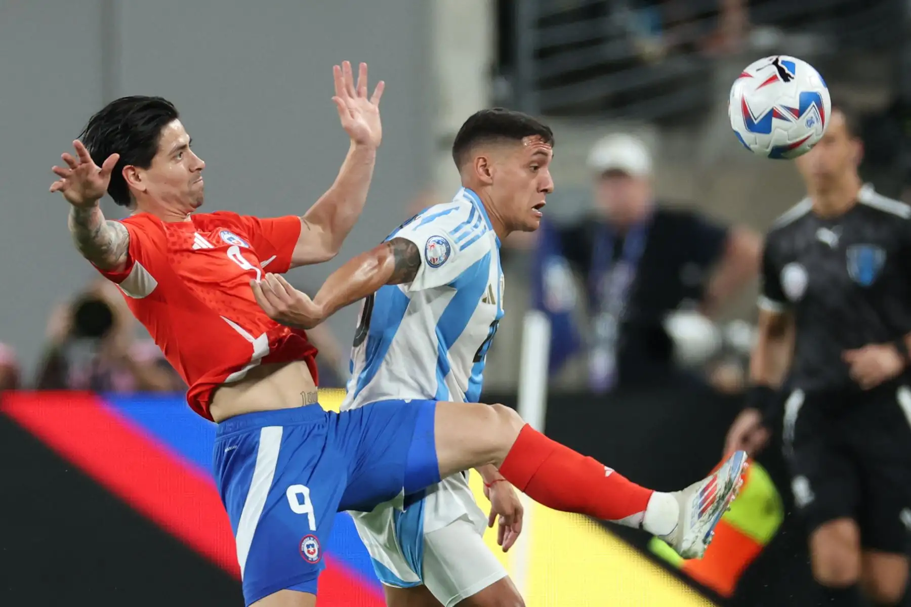 El delantero de Chile Víctor Dávila lucha por el balón con el defensor de Argentina Nahuel Molina Lucero durante el torneo de fútbol del grupo Copa América Conmebol 2024, un partido entre Chile y Argentina. Foto: ANDINA/AFP