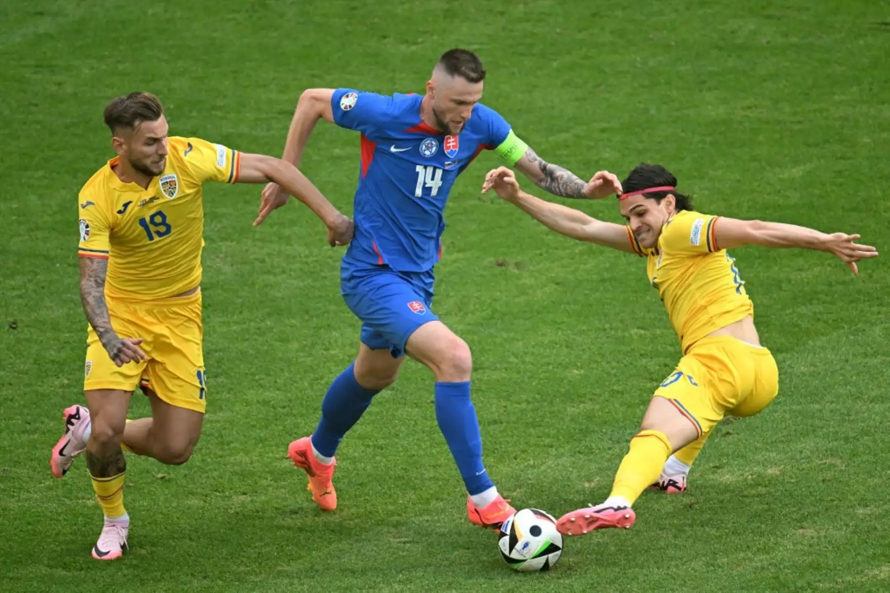 El defensor de Eslovaquia Milan Skriniar lucha por el balón con el delantero rumano Denis Dragus  y el centrocampista  Hagi durante el partido de fútbol de la UEFA Euro 2024 Grupo E entre Eslovaquia y Rumania en el Frankfurt Arena el 26 de junio de 2024. Foto: AFP