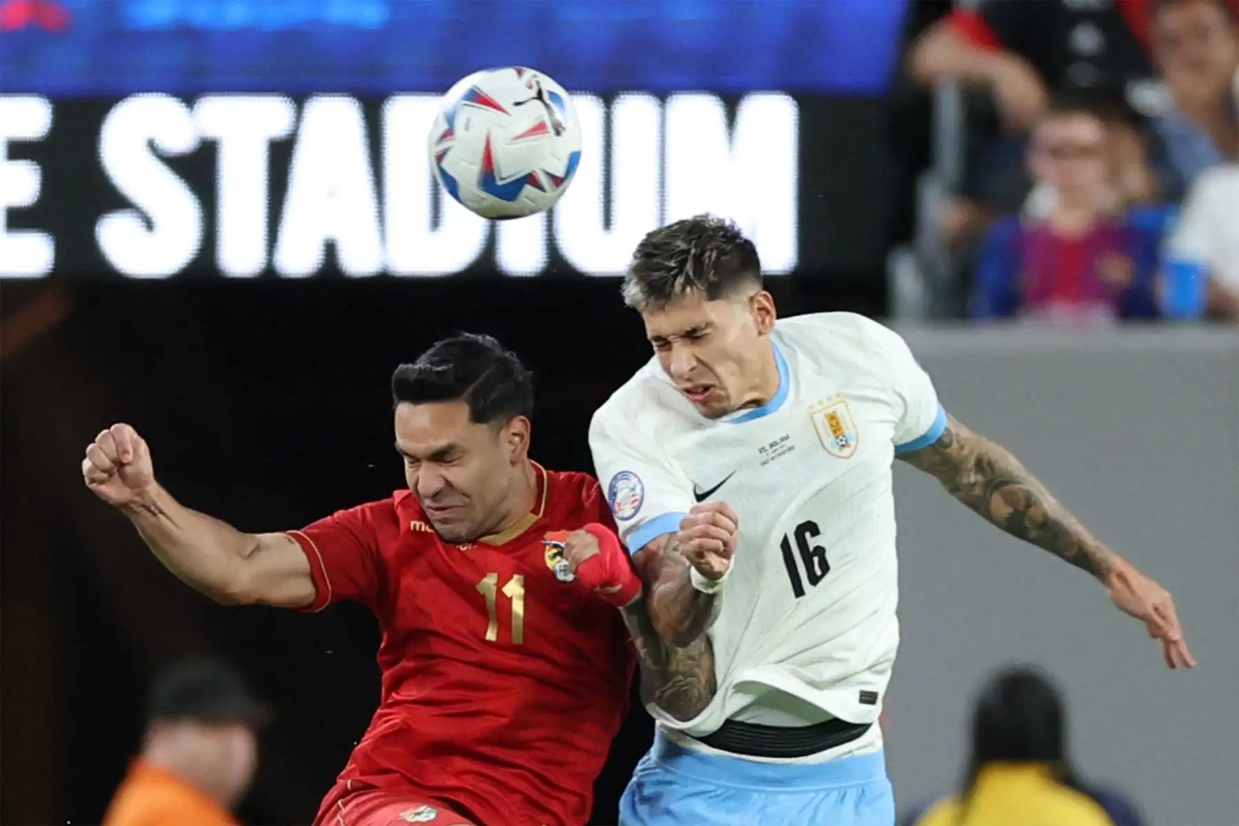 El delantero boliviano Carmelo Algaranaz encabeza el balón con el defensor uruguayo  Mathias Olivera durante el partido de fútbol del grupo C del torneo Copa América Conmebol 2024 entre Uruguay y Bolivia. Foto: ANDINA/AFP