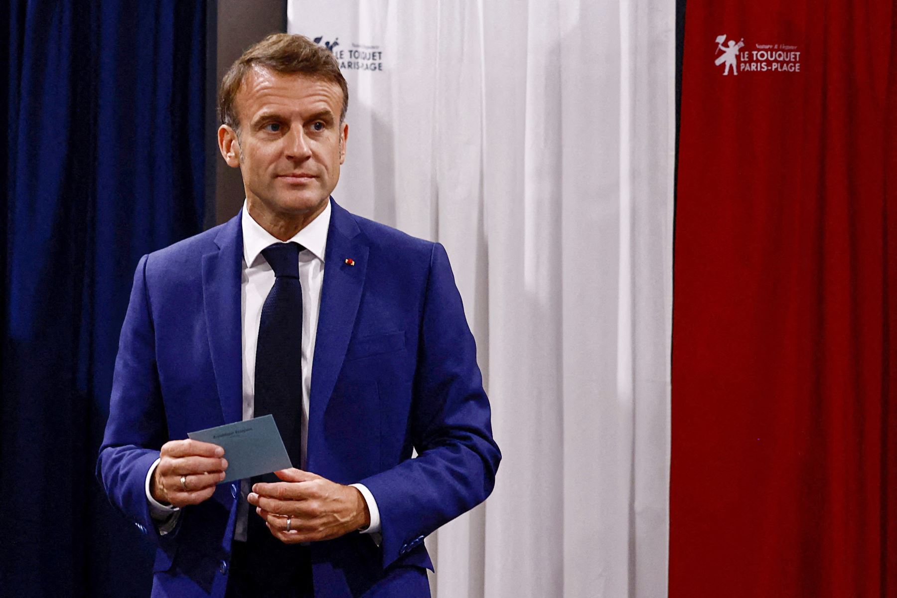 El presidente de Francia, Emmanuel Macron, abandona las urnas antes de emitir su voto en la primera vuelta de las elecciones parlamentarias. AFP