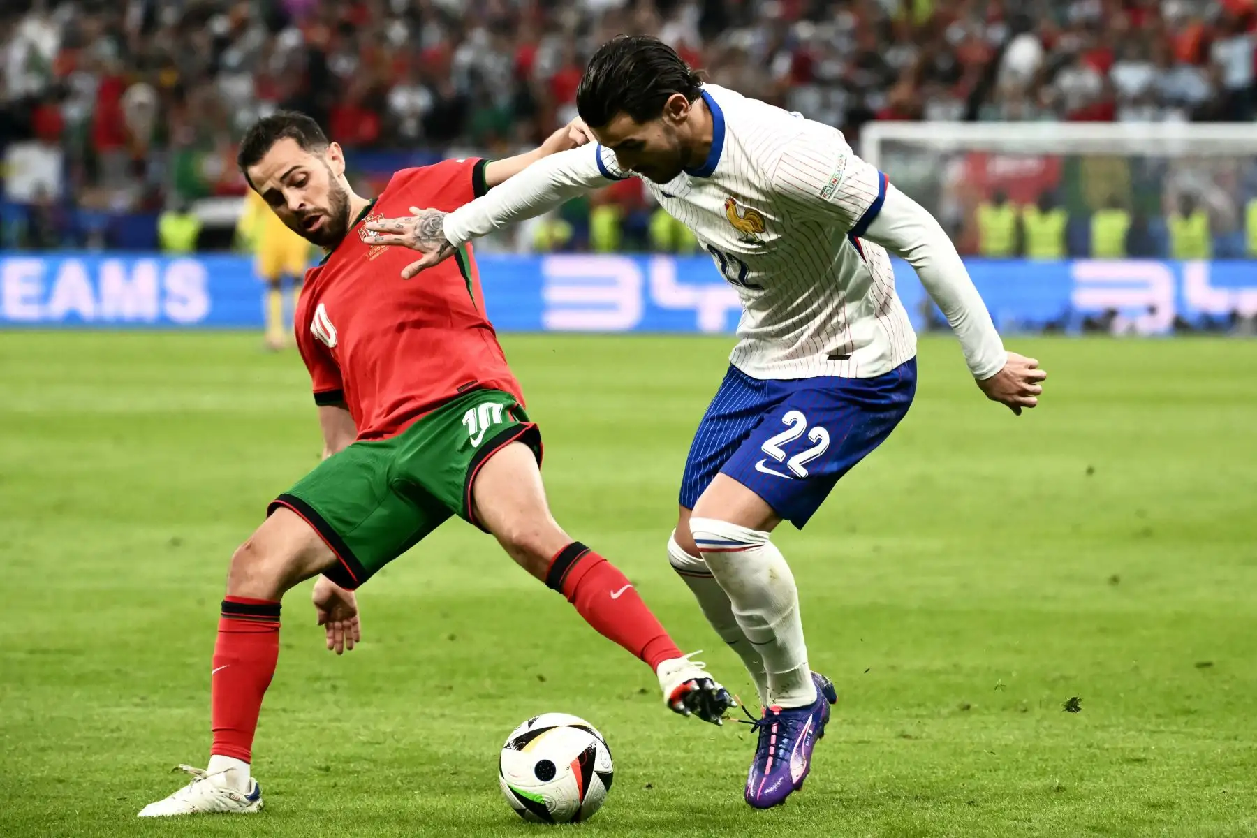 El centrocampista portugués  Bernardo Silva lucha por el balón con el defensor francés  Theo Hernandez durante el partido de fútbol de cuartos de final de la UEFA Euro 2024 entre Portugal y Francia. Foto: ANDINA/AFP