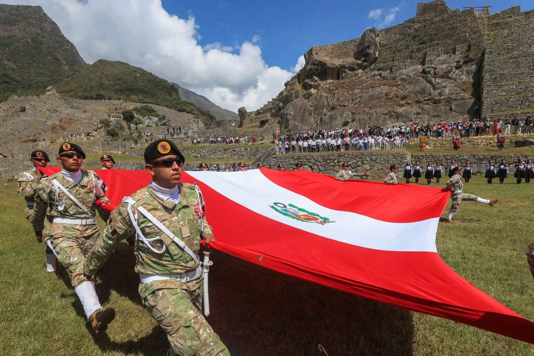 Con motivo del 203º Aniversario de la Proclamación de la Independencia Nacional, la región de Cusco celebra una ceremonia especial por Fiestas Patrias y el Bicentenario. Personal de la 5ª Brigada de Montaña E.P. posa con turistas y trabajadores en la cima del Parque Arqueológico de Machu Picchu. ANDINA/Presidencia