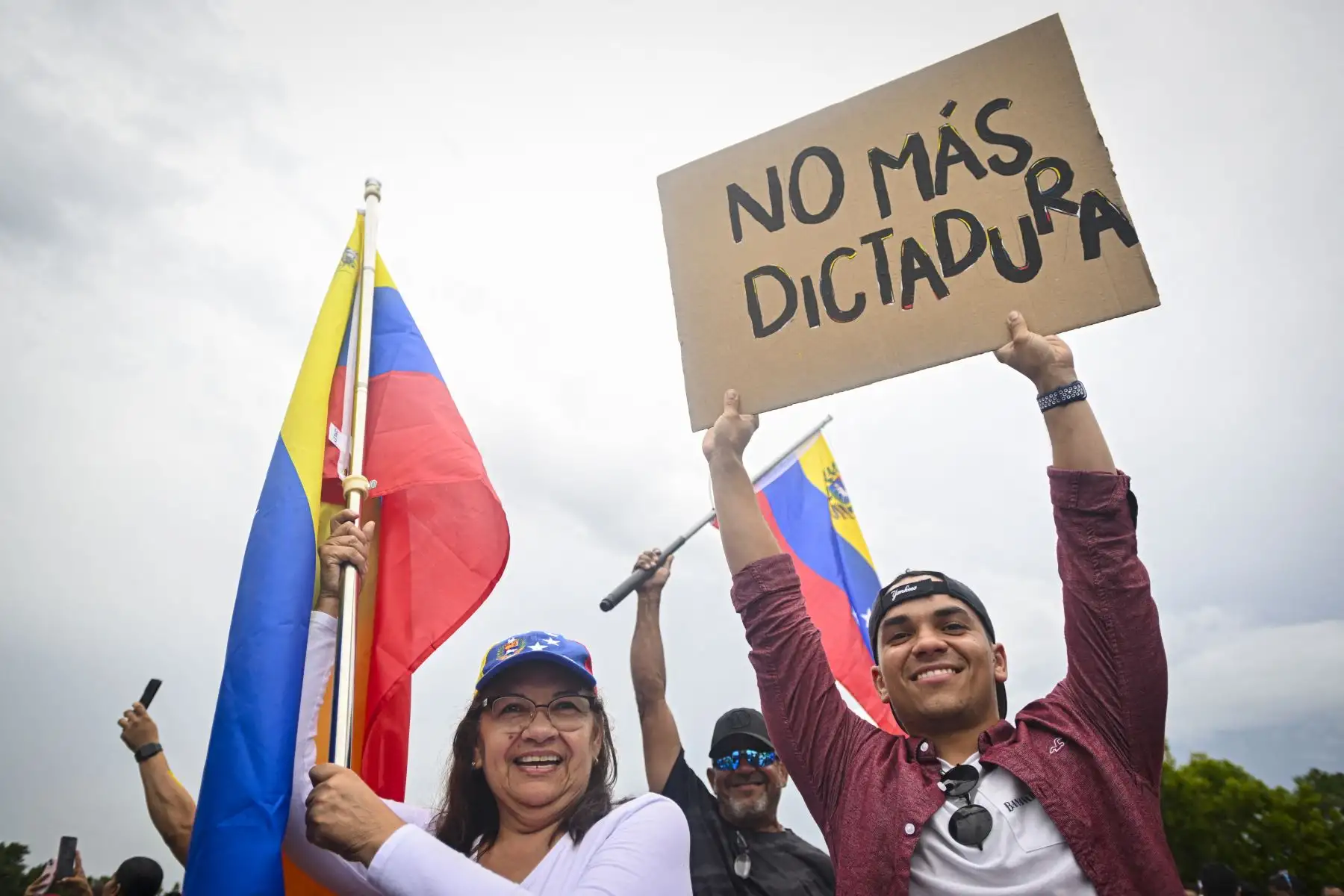 Un manifestante sostiene una pancarta mientras los venezolanos se manifiestan en apoyo de un cambio en el liderazgo político presidencial durante las elecciones presidenciales en Venezuela 4 en Orlando, Florida. AFP