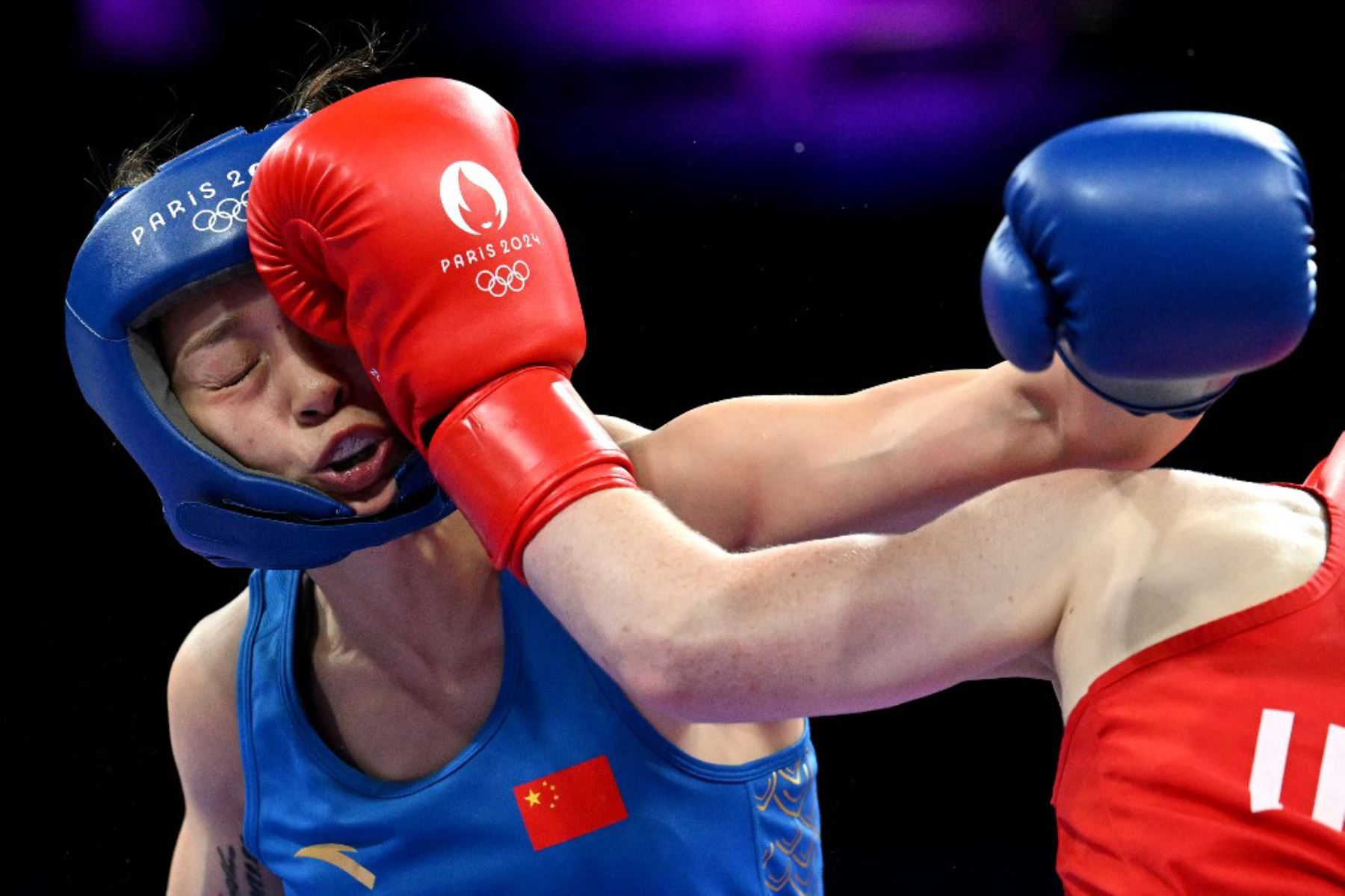 La china Chang Yuan recibe un puñetazo de la irlandesa Jennifer Lehane en la ronda preliminar femenina de 16 de boxeo de 54 kg durante los Juegos Olímpicos de París. Foto: AFP