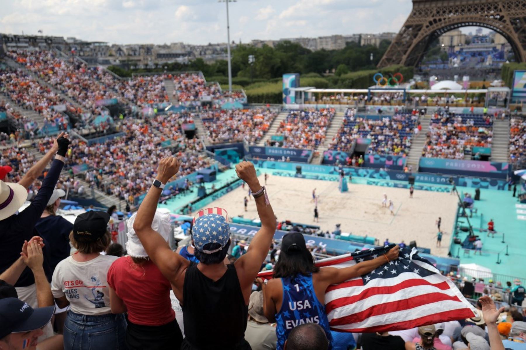 Hinchas estadounidenses animan a su país en el partido de voleibol de playa del grupo F masculino entre España y Estados Unidos durante los Juegos Olímpicos de París 2024 en el Estadio de la Torre Eiffel el 2 de agosto. Foto: AFP