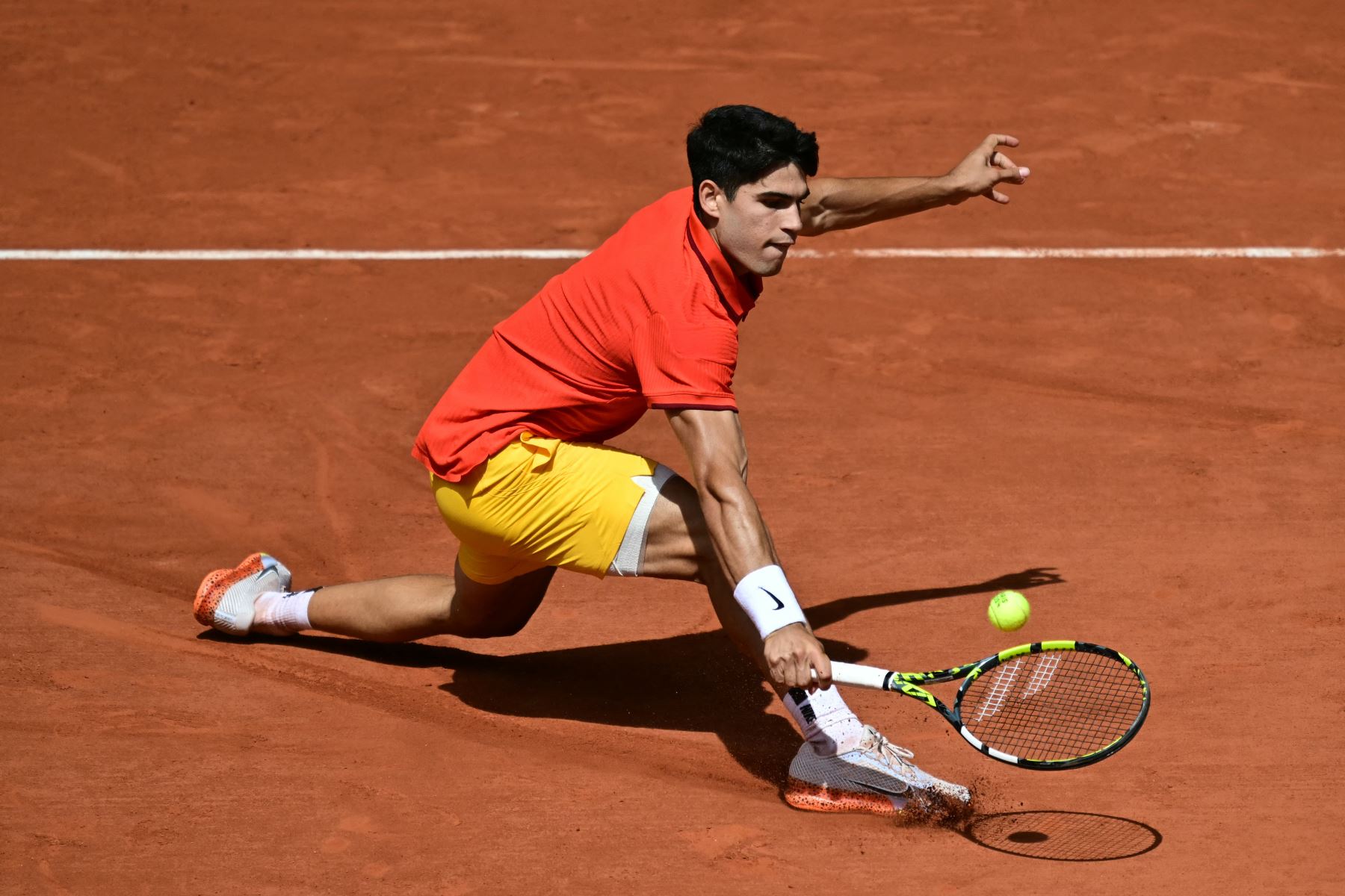 El español Carlos Alcaraz regresa al serbio Novak Djokovic durante su último partido de tenis masculino en la cancha Philippe-Chatrier del estadio Roland-Garros durante los Juegos Olímpicos de París 2024. AFP