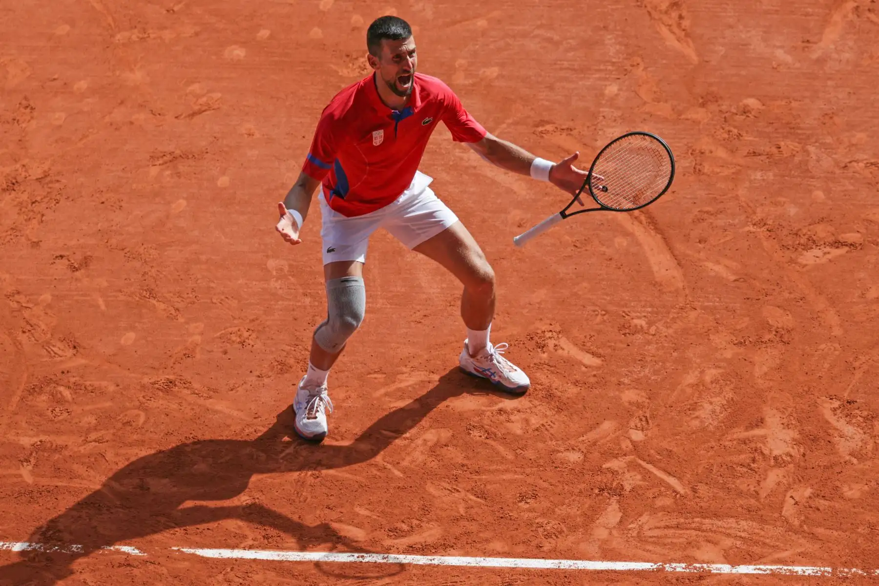 El serbio Novak Djokovic reacciona tras vencer al español Carlos Alcaraz en su último partido de tenis individual masculino en la cancha Philippe-Chatrier del estadio Roland-Garros durante los Juegos Olímpicos de París 2024. AFP