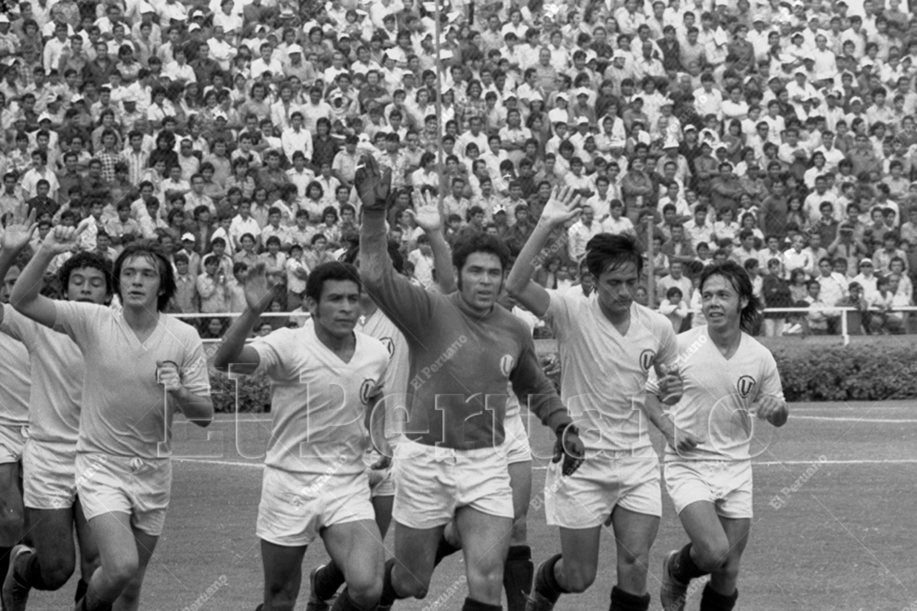 Lima - 29 diciembre 1974 / Jugadores de Universitario de Deportes, capitaneados por Héctor Chumpitaz, dan la vuelta olímpica luego de vencer 1-0 a Nacional de Uruguay y ganar el torneo internacional "Señor de los Milagros" realizado por la inauguración del estadio de Alianza Lima. Foto: Archivo Histórico de El Peruano / Raúl Sagástegui