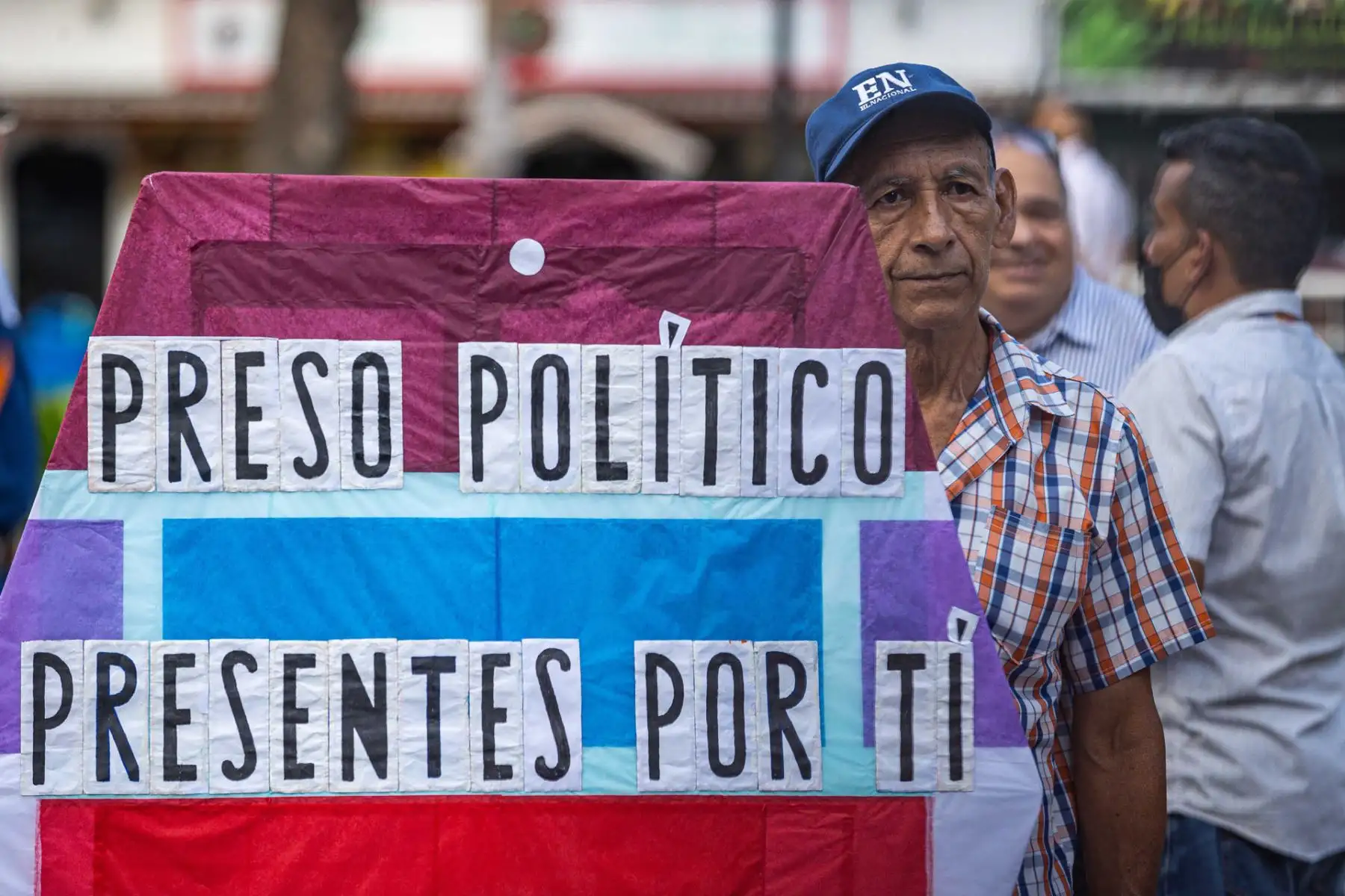 Un hombre sostiene un cartel durante una gran vigilia nacional por los presos políticos convocada por la oposición, este jueves 8 de agosto en la plaza Los Palos Grandes, en Caracas, Venezuela. Foto: EFE