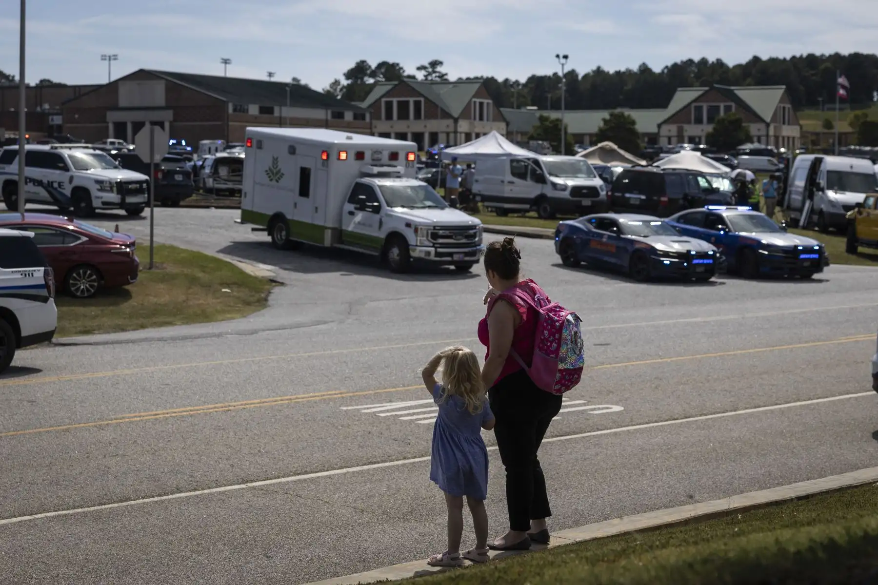 Una niña y su madre observan cómo las fuerzas del orden y los socorristas rodean la escuela secundaria Apalachee en Winder, Georgia.
Foto: AFP