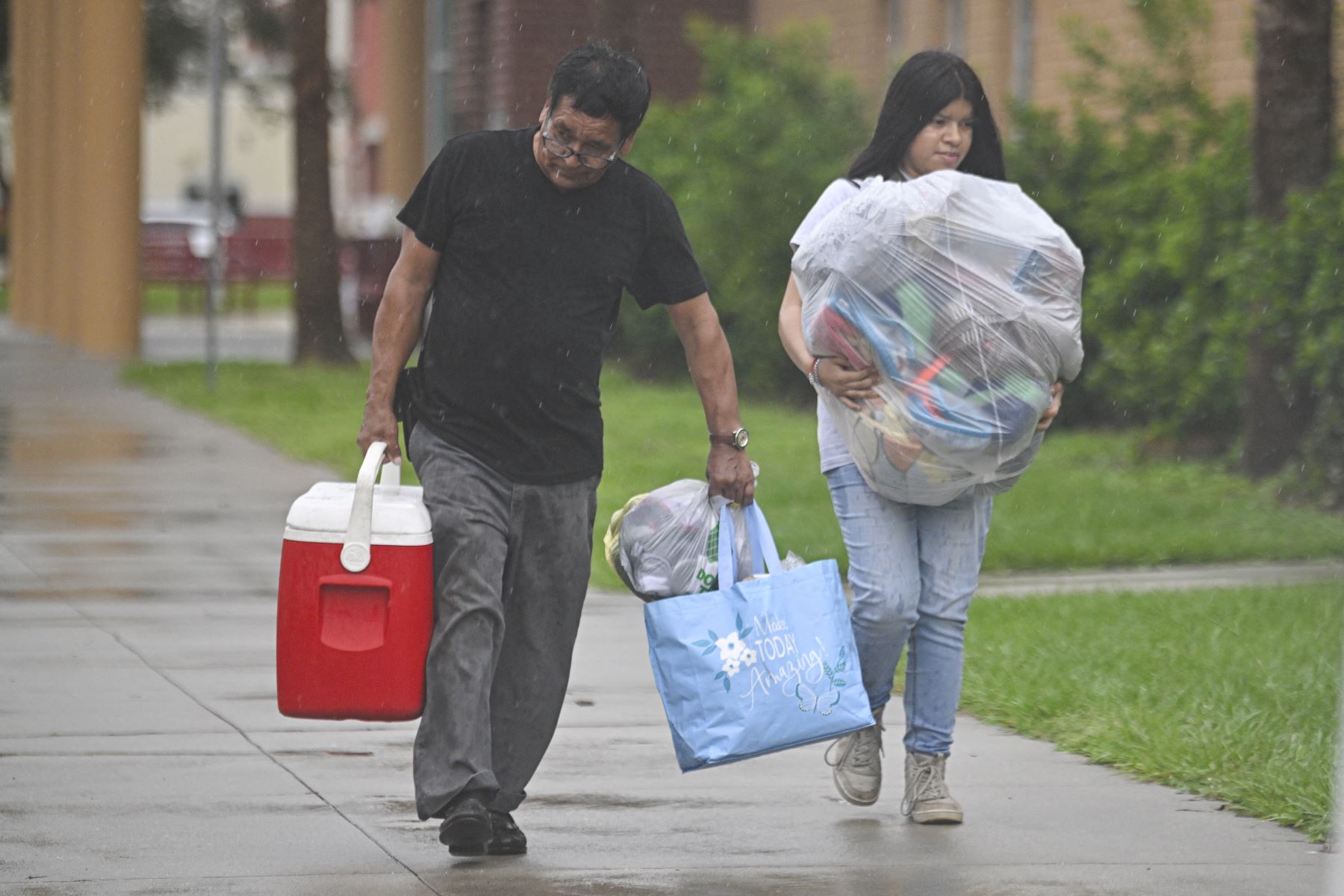 La gente llega al refugio de la escuela secundaria de Buffalo Creek antes de que el huracán Milton toque tierra en Bradenton, Florida. Foto: AFP