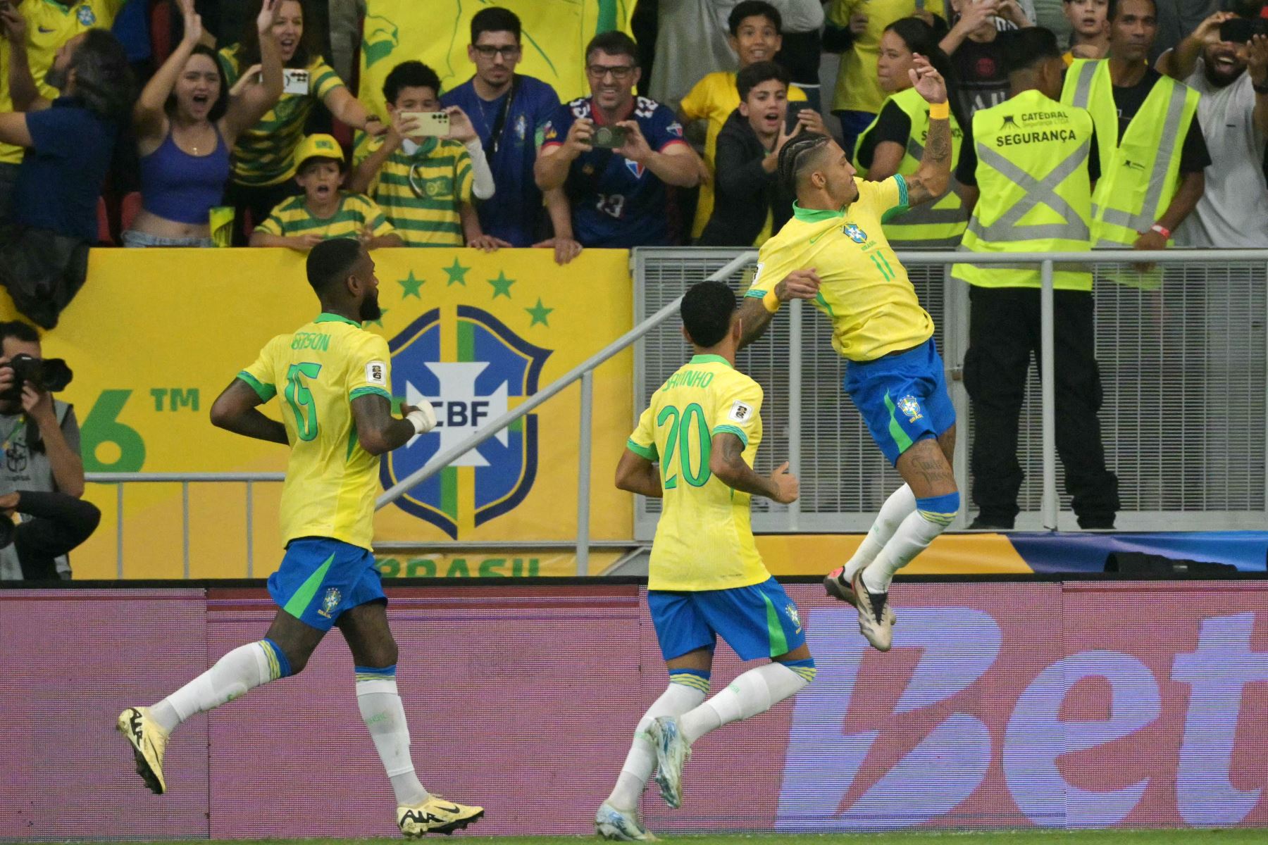 El delantero brasileño  Raphinha celebra con sus compañeros el delantero  Savinho y el mediocampista Bruno Guimaraes después de anotar un gol durante el partido de fútbol de las eliminatorias sudamericanas para la Copa Mundial de la FIFA 2026 entre Brasil y Perú. AFP