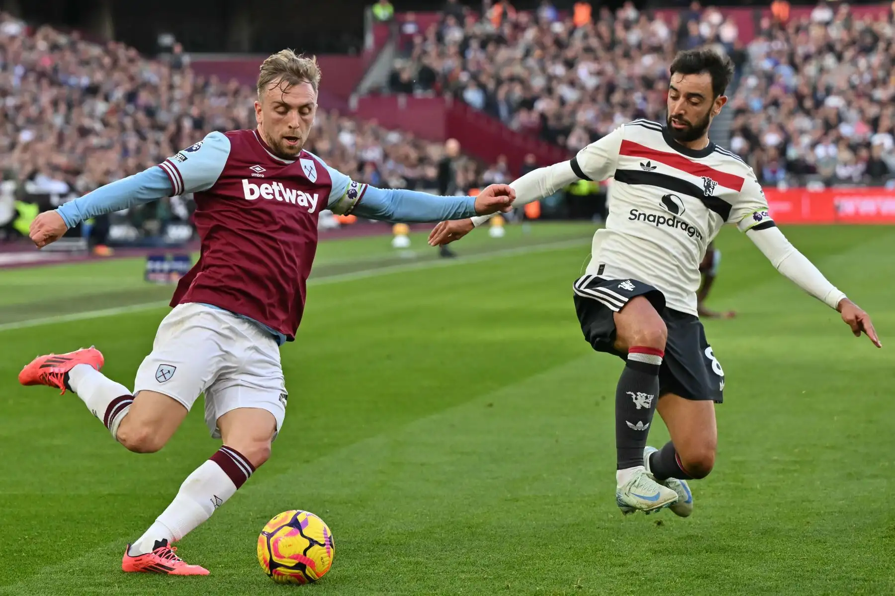 El delantero inglés del West Ham United  Jarrod Bowen compite con el centrocampista portugués del Manchester United  Bruno Fernandes  durante el partido de fútbol de la Premier League inglesa entre West Ham United y Manchester United. AFP