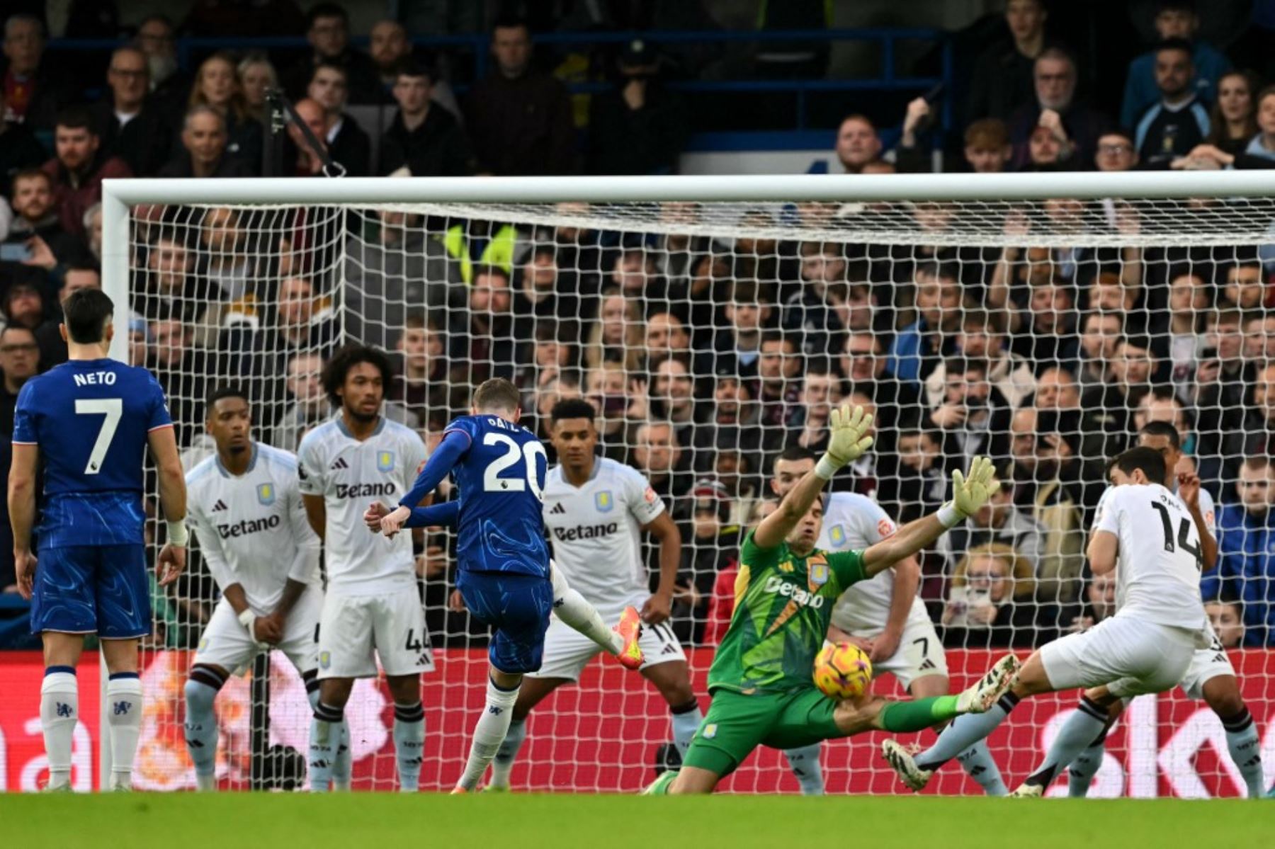 El centrocampista inglés del Chelsea #20, Cole Palmer, dispara, pero tiene el tiro salvado por el portero argentino del Aston Villa #23 Emiliano Martínez durante el partido de fútbol de la Premier League inglesa entre Chelsea y Aston Villa en Stamford Bridge en Londres el 1 de diciembre de 2024. (Foto de Glyn KIRK / AFP)