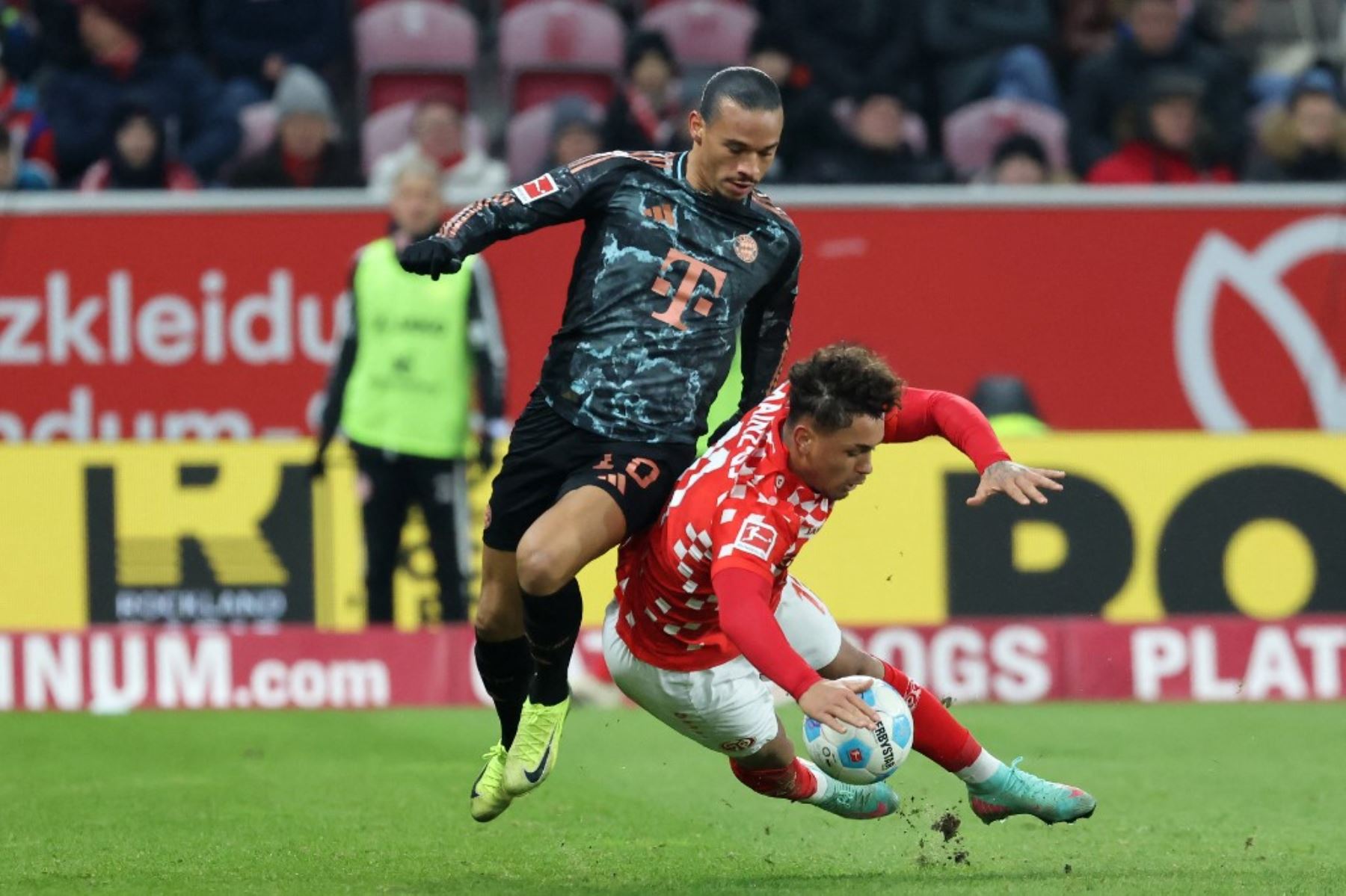 El delantero alemán #10 del Bayern de Múnich, Leroy Sane (izbra), y el delantero alemán #11 del Mainz, Armindo Sieb, compiten por el balón durante el partido de fútbol de la Bundesliga de primera división alemana entre 1 FSV Mainz 05 y FC Bayern Munich en Mainz, oeste de Alemania el 14 de diciembre de 2024. (Foto de Daniel ROLAND / AFP)