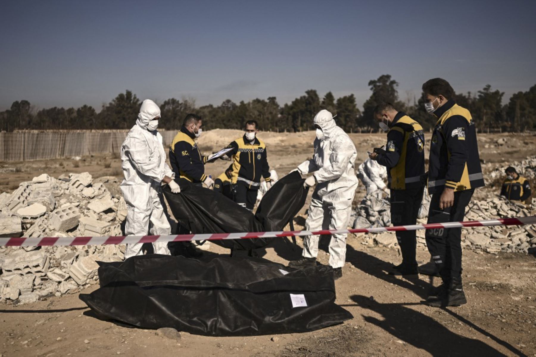 Miembros de la defensa civil de los Cascos Blancos de Siria transportan bolsas para cadáveres que contienen restos humanos que fueron recuperados de una fosa común, en Damasco, el 16 de diciembre de 2024. Los rebeldes liderados por islamistas tomaron Damasco en una ofensiva relámpago el 8 de diciembre, derrocando al presidente Bashar al-Assad y poniendo fin a cinco décadas de gobierno de Baath en Siria. Según el Observatorio Sirio de Derechos Humanos, más de 100.000 personas murieron en las cárceles y centr