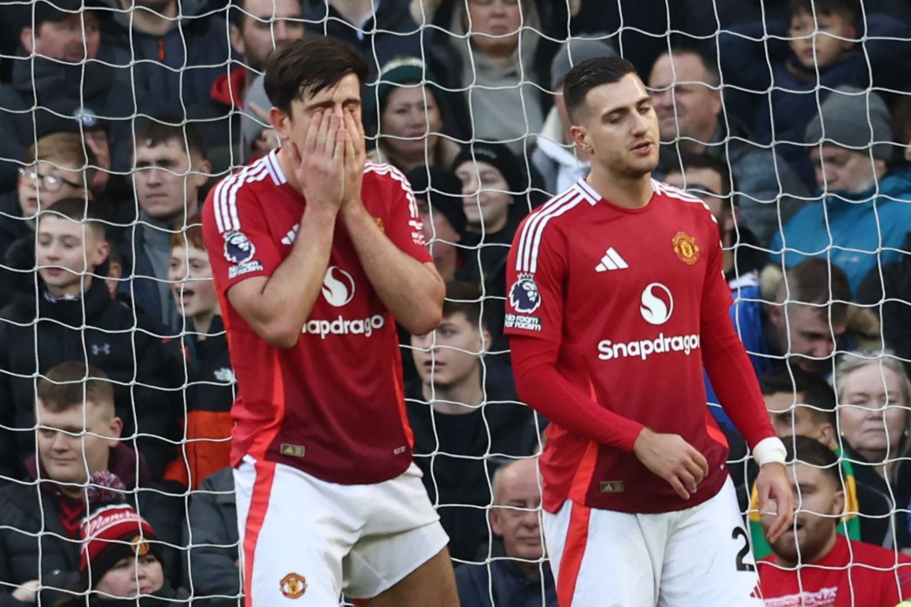 El defensa inglés del Manchester United #05 Harry Maguire y el defensa portugués del Manchester United #20 Diogo Dalot reaccionan al conceder el gol inaugural durante el partido de fútbol de la Premier League inglesa entre el Manchester United y el Bournemouth en Old Trafford en Manchester, noroeste de Inglaterra, el 22 de diciembre de 2024. (Foto de Darren Staples / AFP)