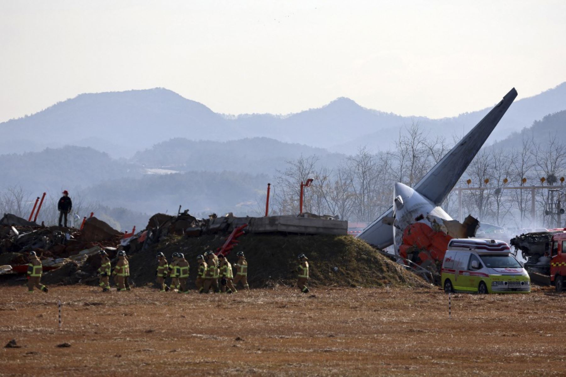 Se ve al personal de rescate junto a la sección de cola de un avión de la serie Boeing 737-800 de Jeju Air después de que el avión se estrellara y estallara en llamas en el Aeropuerto Internacional de Muan, en la provincia de South Jeolla, a unos 288 kilómetros al suroeste de Seúl, el 29 de diciembre de 2024. Un avión de Jeju Air que transportaba a 181 personas de Bangkok a Corea del Sur se estrelló al llegar el 29 de diciembre, las autoridades dijeron a la AFP, con 29 muertos confirmados y un video dramáti