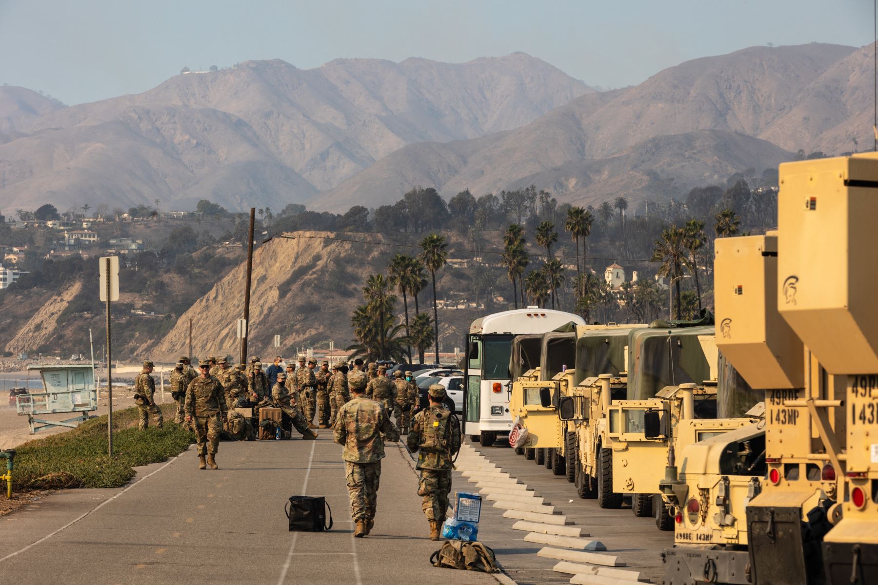 Miembros de la Guardia Nacional del Ejército almuerzan a lo largo de la Pacific Coast Highway mientras están desplegados para ayudar con varios incendios en Los Ángeles. AFP