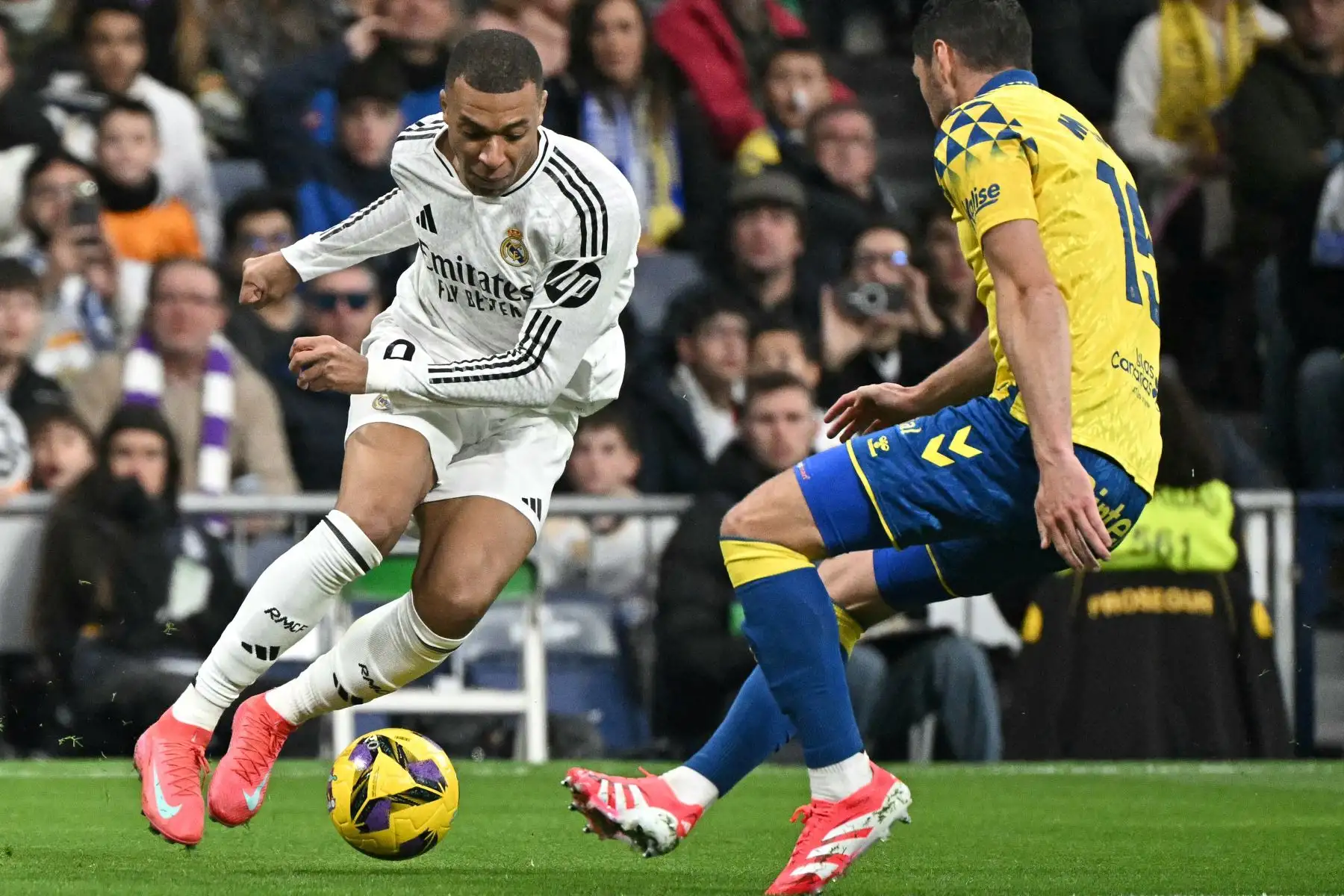 El delantero francés del Real Madrid , Kylian Mbappé lucha por el balón con el defensor escocés de Las Palmas, Scott McKenna durante el partido de fútbol de la liga española entre el Real Madrid CF y la UD Las Palmas en el estadio Santiago Bernabeu de Madrid.
Foto: AFP