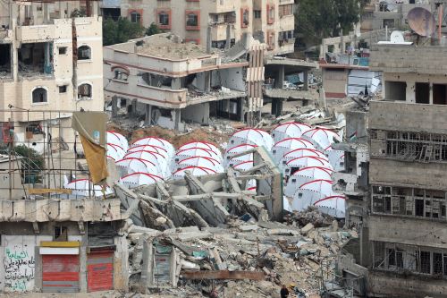 Tiendas de campaña construidas entre los escombros de una construcción en el barrio de Al-Shujiyya, en la ciudad de Gaza. Foto: AFP