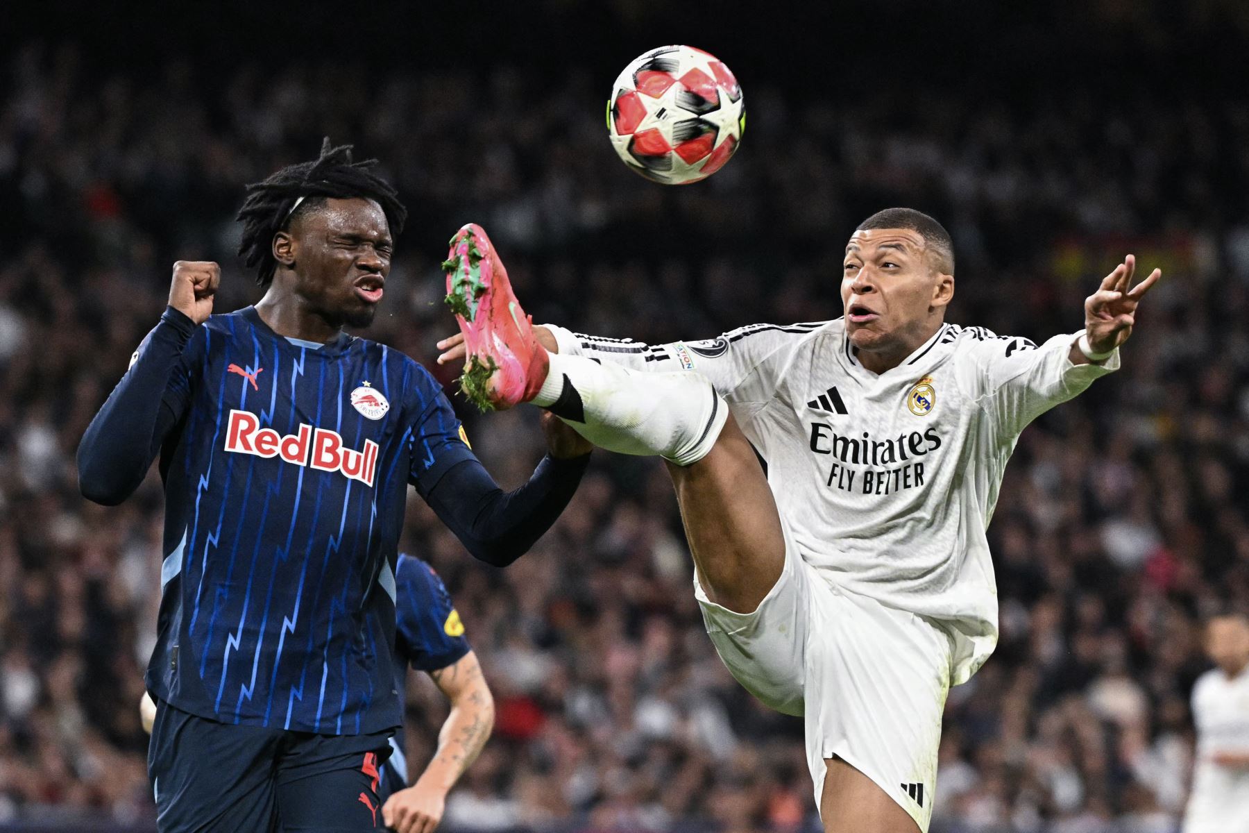 El delantero francés del Real Madrid  Kylian Mbappe controla el balón desafiado por el defensor alemán de Salzburgo  Hendry Blank durante la Liga de Campeones de la UEFA, partido de fútbol de fase liguera entre el Real Madrid CF y el FC Salzburg. AFP