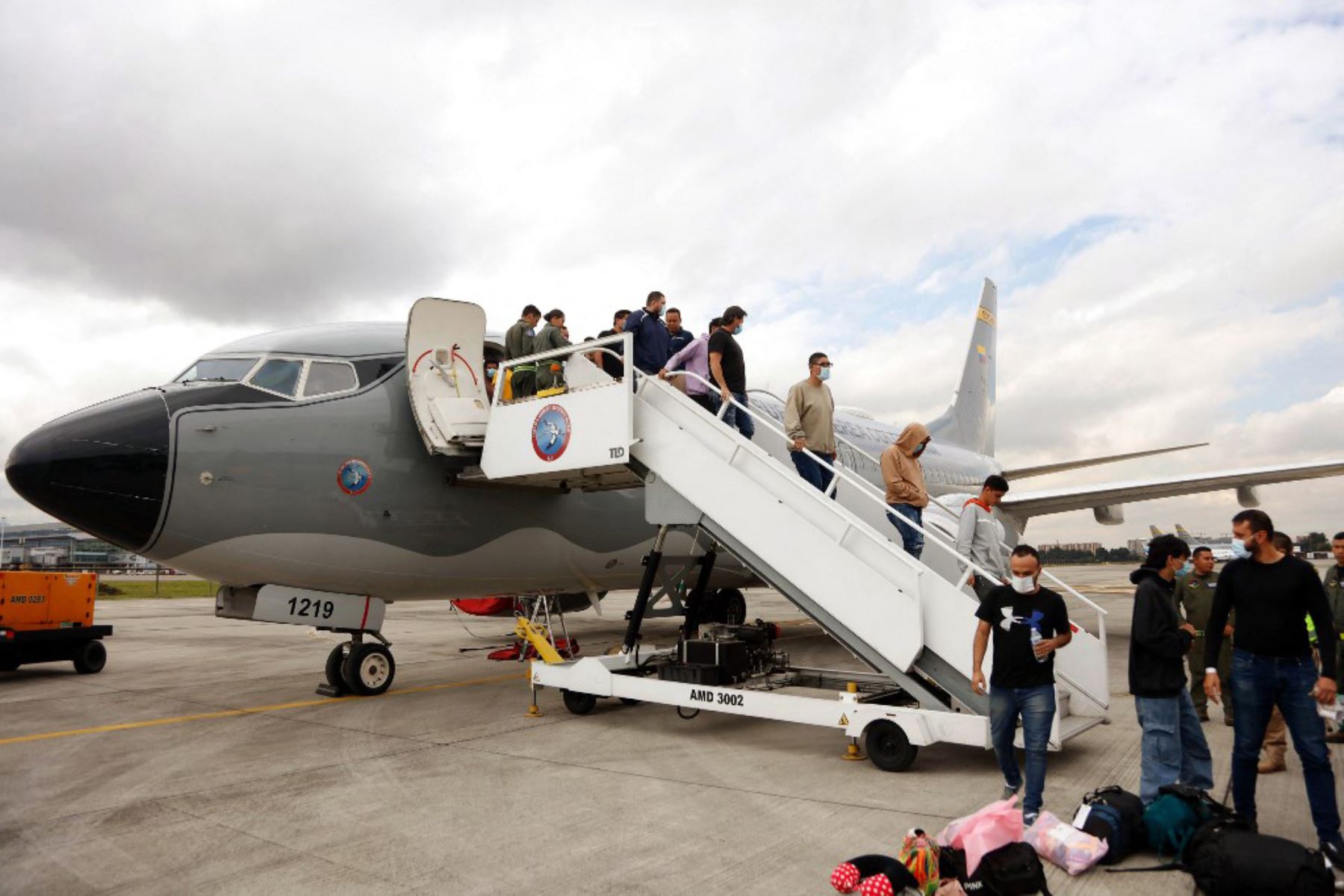 Imagen publicada por la oficina de prensa del Ministerio de Relaciones Exteriores de Colombia muestra a migrantes descendiendo de un avión de la Fuerza Aérea Colombiana después de ser deportados de Estados Unidos en Bogotá el 28 de enero de 2025. Foto: AFP