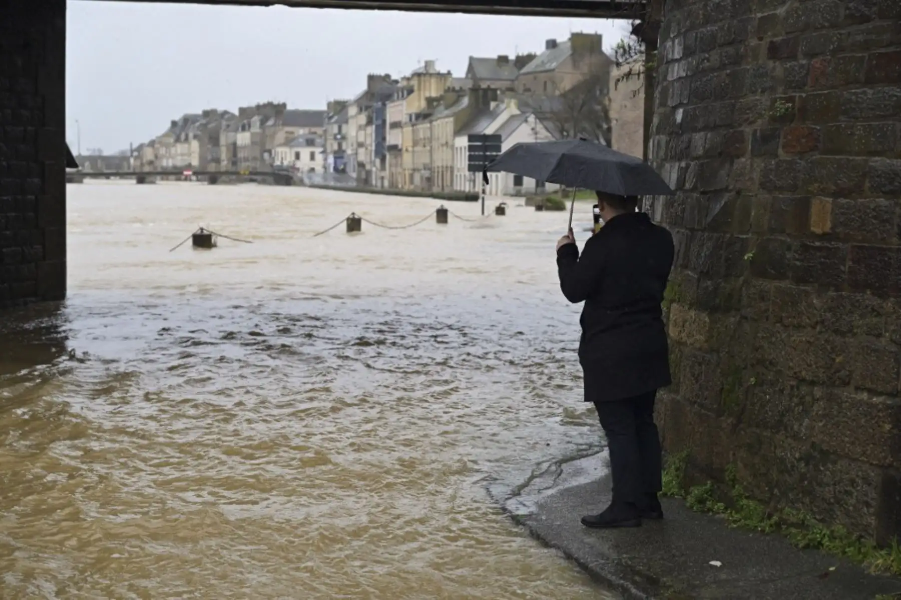 Un hombre toma una foto del desbordamiento del río Vilaine en Redon, al oeste de Francia, el 29 de enero de 2025. Las regiones de Loire-Atlantique y Morbihan, así como Ille-et-Vilaine, donde 600 personas han sido evacuadas desde el 26 de enero, fueron puestas en alerta roja por inundaciones por Meteo-France el 28 de enero, después de la tormenta Herminia. (Foto de Damien MEYER / AFP)