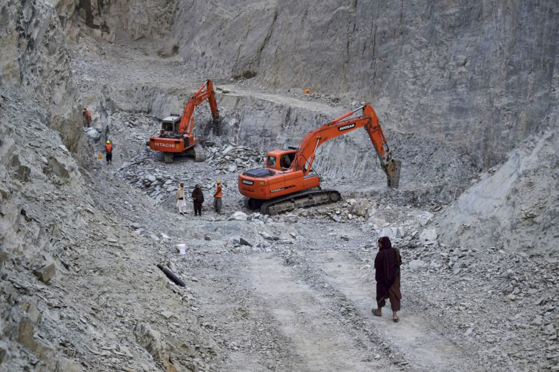 Esta fotografía muestra a trabajadores afganos de pie junto a excavadoras en una mina nefrita en las montañas del distrito de Goshta, provincia de Nangarhar. Foto: AFP