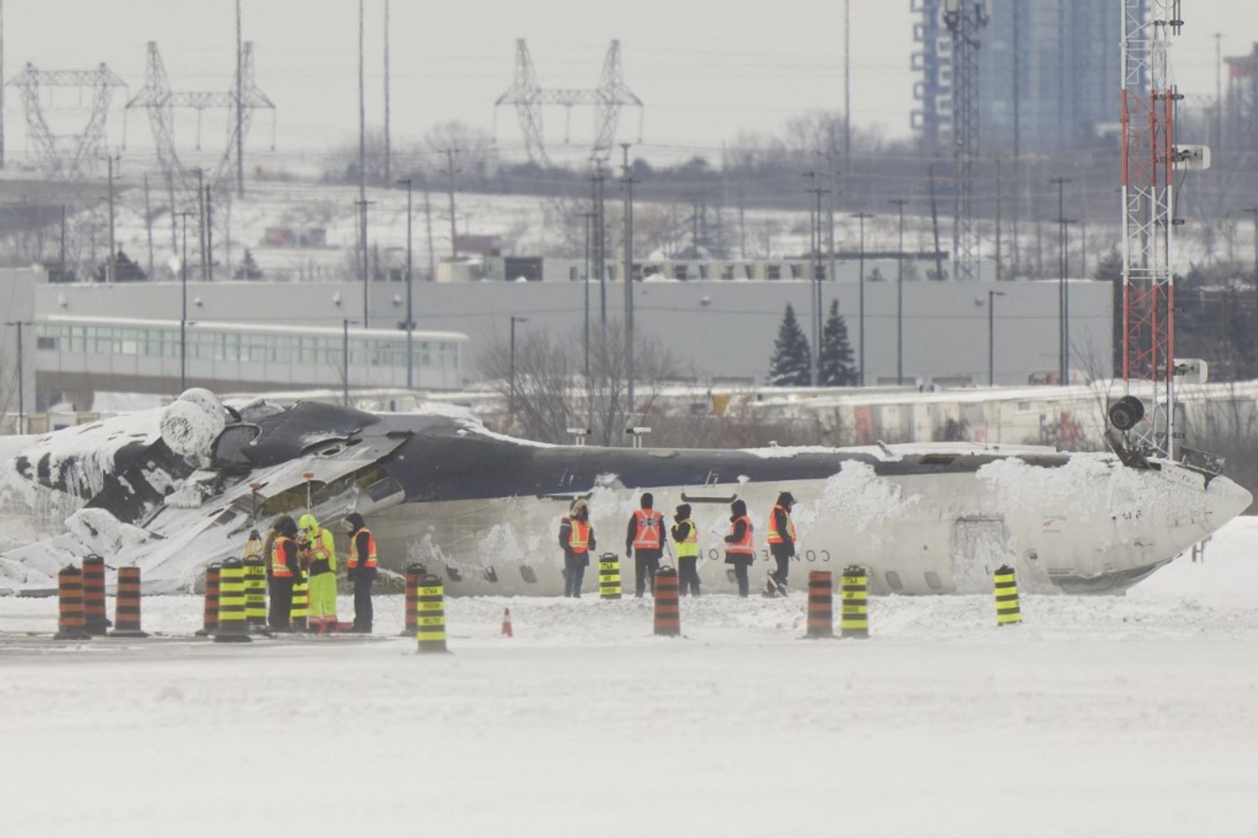 Investigadores examinan los restos de un avión de Delta Air Lines un día después de que se estrellara al aterrizar en el Aeropuerto Internacional Pearson de Toronto en Toronto, Ontario, el 18 de febrero de 2025. (Foto de Geoff Robins / AFP)