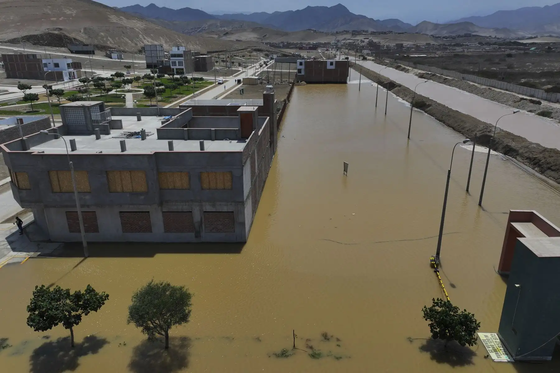 El desborde del río Chilca ha provocado una inundación que ha dejado intransitable el acceso vehicular a la entrada de Pucusana, dificultando el desplazamiento de quienes viajan desde la Panamericana Sur hacia el balneario y viceversa. Obreros se encuentran limpiando la zona con maquinaria pesada y motobombas. Foto: ANDINA/Jhonel Rodríguez Robles