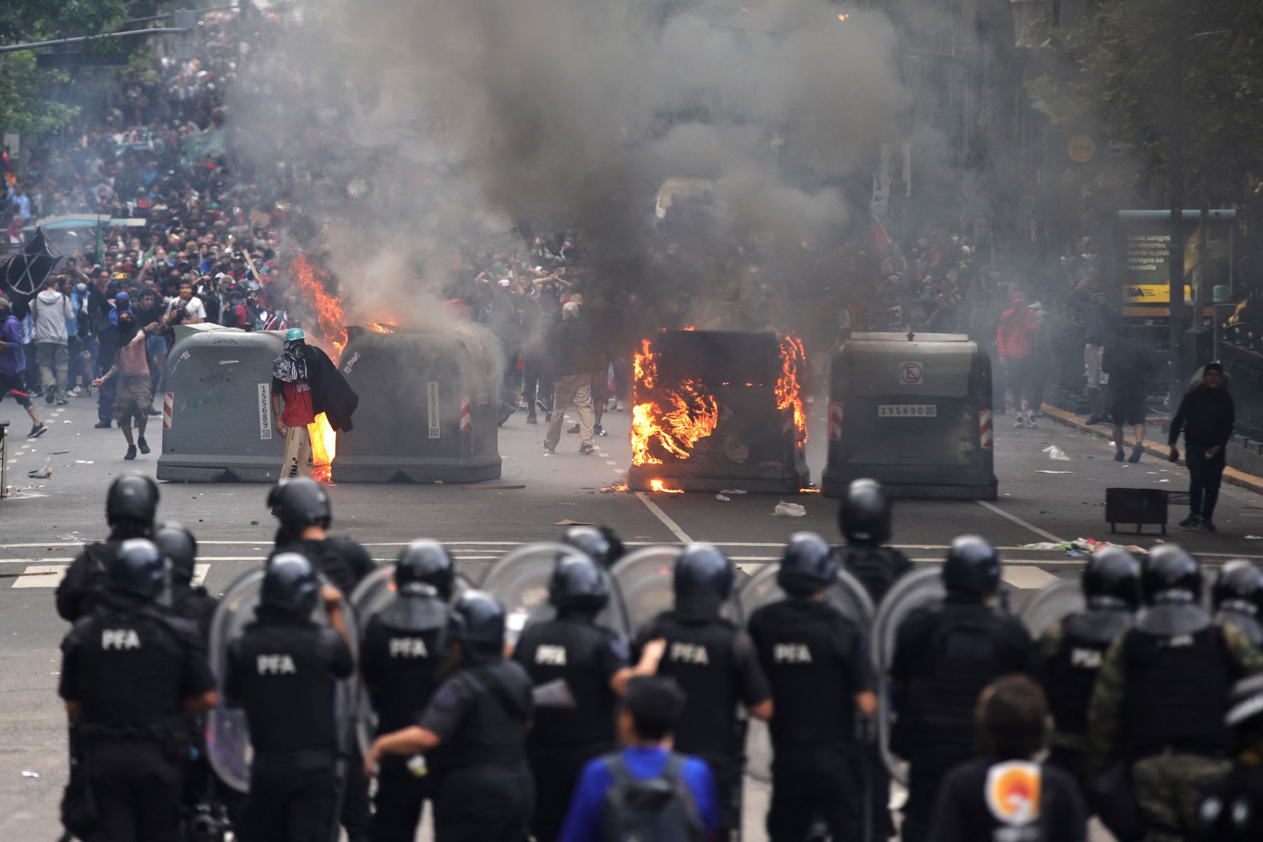 Policía antidisturbios se enfrenta a manifestantes, durante una protesta de jubilados apoyados por barristas en Buenos Aires. Foto: AFP