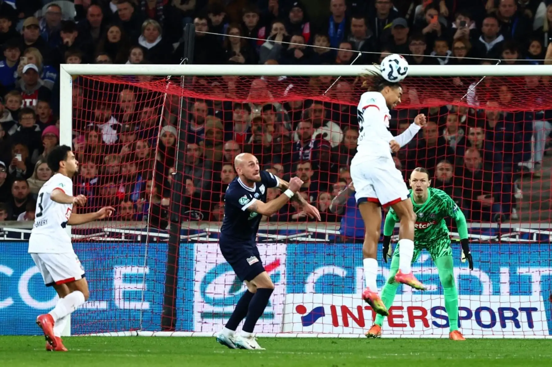 El delantero francés del Paris Saint-Germain, Bradley Barcola, salta para cabecear el balón durante el partido de semifinales de la Copa de Francia entre el USL Dunkirk y el Paris Saint-Germain (PSG) en el estadio Pierre-Mauroy en Villeneuve-d