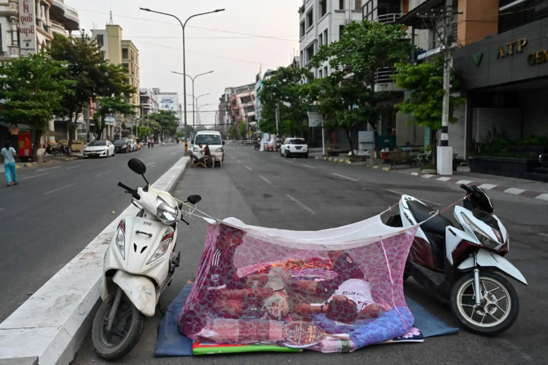 Personas duermen en una tienda de campaña improvisada en la calle de Mandalay, cinco días después de que un gran terremoto azotara el centro de Myanmar. Foto: AFP
