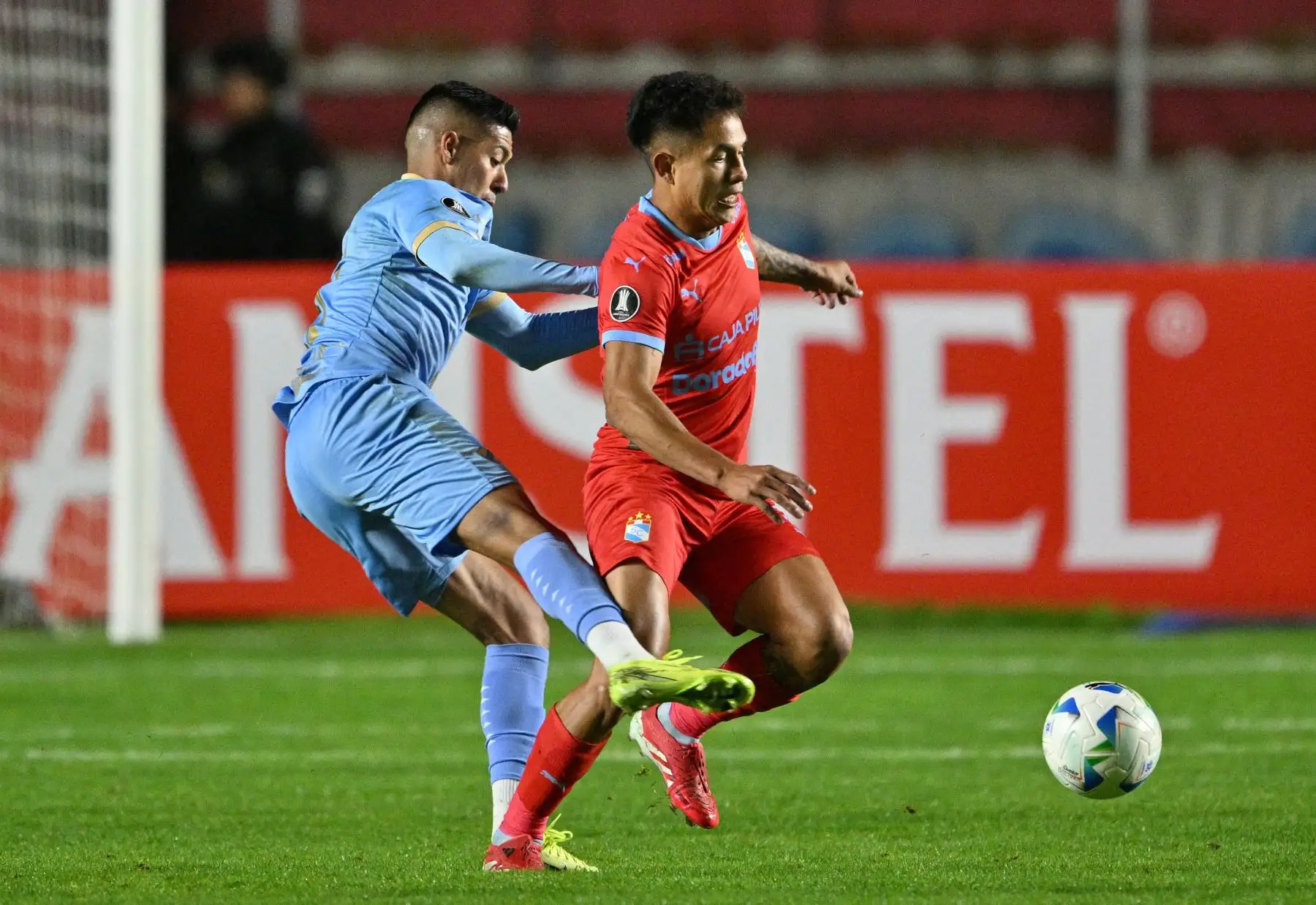El mediocampista  de Bolívar, Ramiro Vaca, y el mediocampista de Sporting Cristal, Christofer Gonzales, luchan por el balón durante el partido de fútbol de la fase de grupos de la Copa Libertadores entre Bolívar de Bolivia y Sporting Cristal de Perú. Foto: AFP