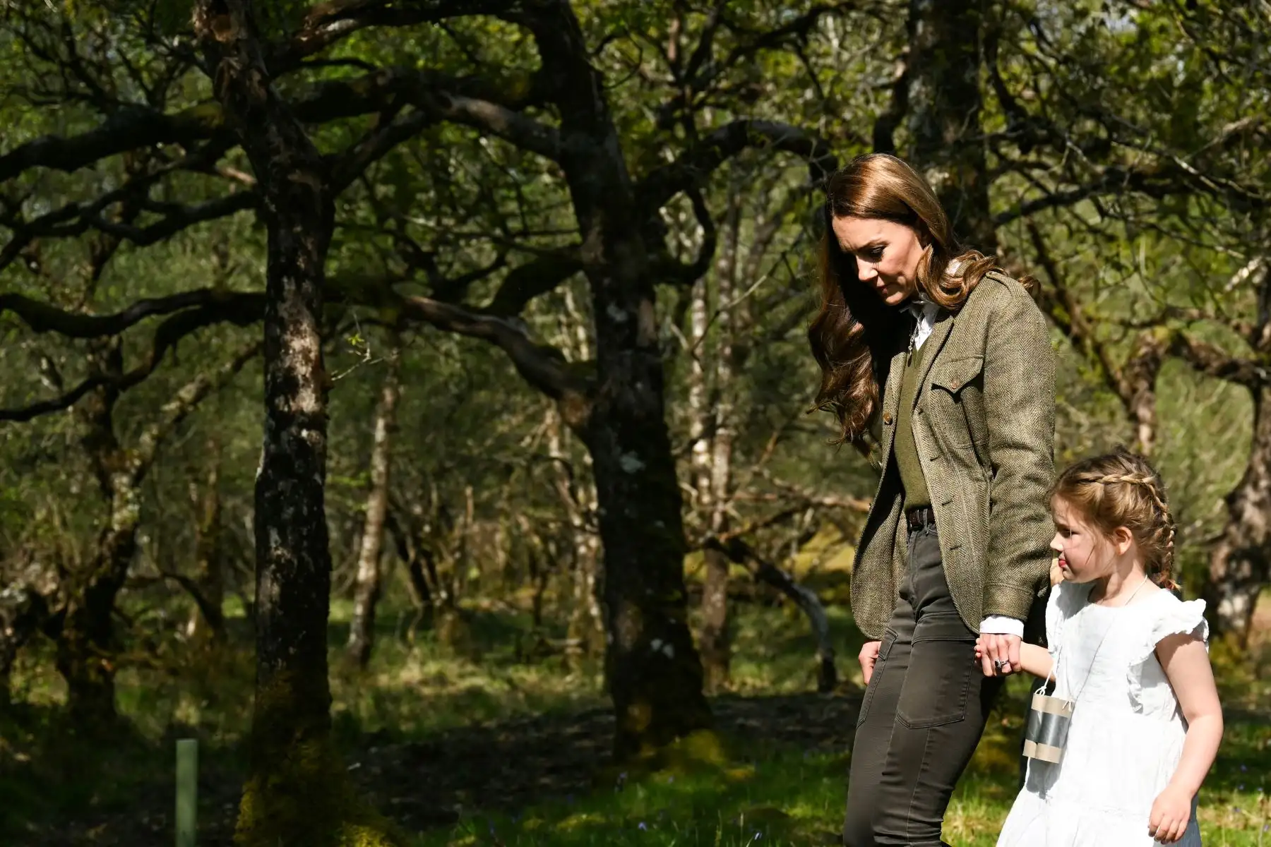 La Princesa de Gales, Catalina de Gran Bretaña sostiene la mano de un niño del grupo Ardura Acorns durante una visita al Bosque Comunitario de Ardura para destacar la importancia de proteger y defender el medio ambiente natural, como parte de su viaje de dos días a la Isla de Mull, en el oeste de Escocia. AFP