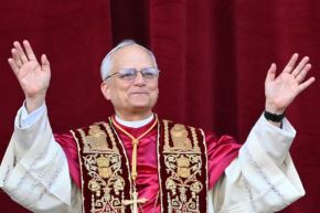 The newly elected Pope Leo XIV, Robert Prevost, arrives at the central balcony of St. Peter
