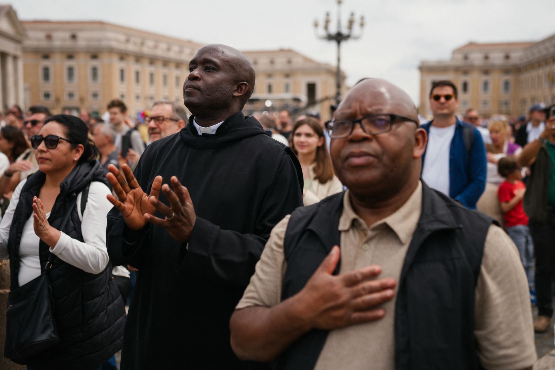 Los fieles reaccionan en la plaza de San Pedro mientras asisten a la oración del Regina Caeli dirigida por el Papa Francisco, en el Vaticano. AFP