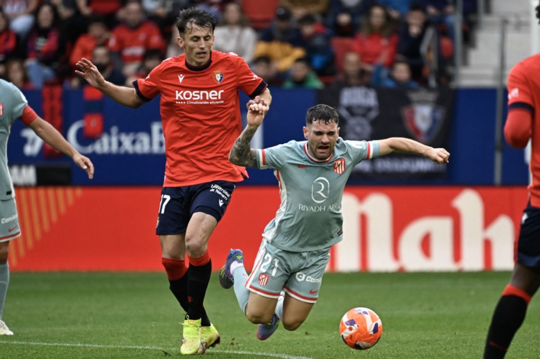 El defensa español del Atlético de Madrid, Javi Galan, cae después de ser abordado por el delantero croata del Osasuna, Ante Budimir, durante el partido de fútbol de la liga española entre el CA Osasuna y el Club Atlético de Madrid en el Estadio El Sadar de Pamplona, el 15 de mayo de 2025. (Foto de ANDER GILLENEA / AFP)