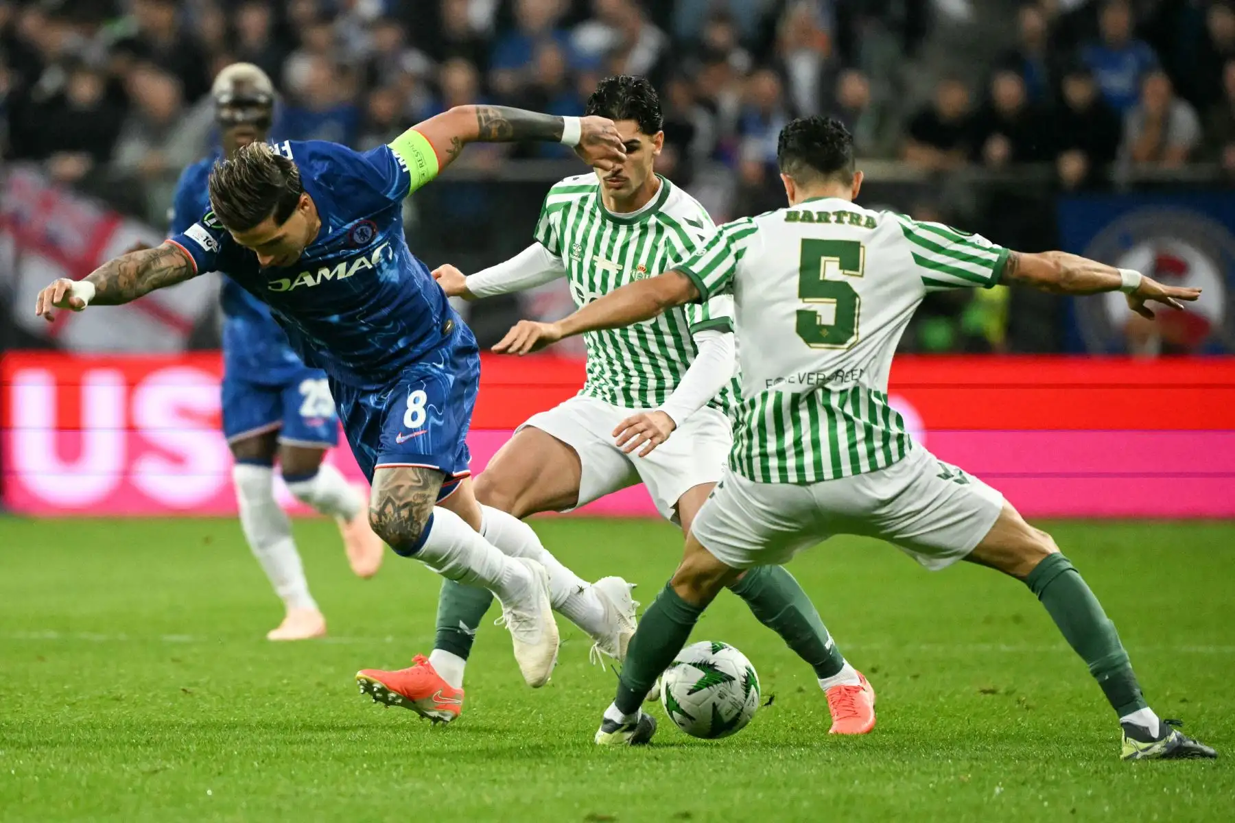 El delantero brasileño del Real Betis, Vitor Hugo Roque Ferreira, el centrocampista estadounidense del Real Betis, Johnny Cardoso, y el defensa español del Real Betis, Marc Bartra, disputan el balón durante la final de la UEFA Conference League entre el Real Betis y el Chelsea. 
Foto: AFP