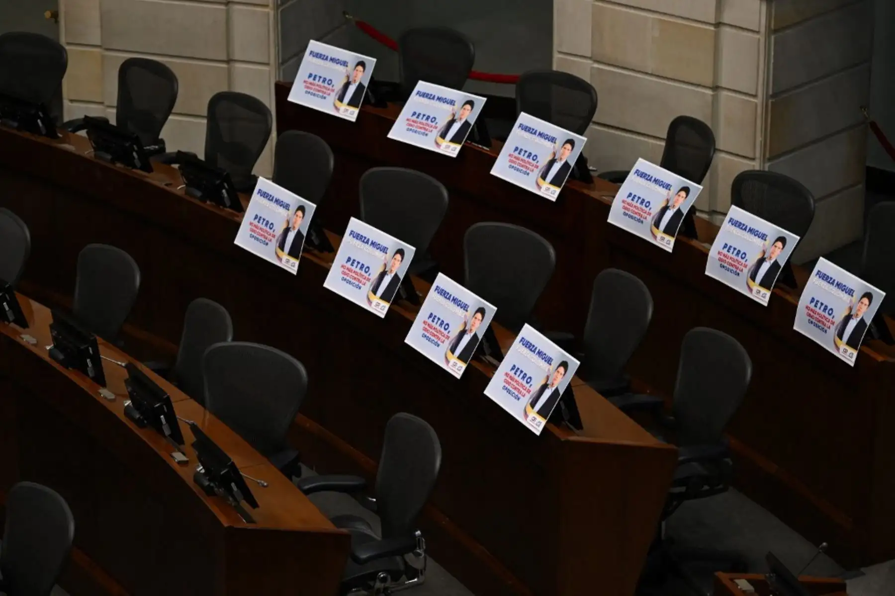 Carteles con la foto del senador y candidato presidencial colombiano Miguel Uribe, que dicen "Fuerza, Miguel", "Fuerza, Colombia", "Petro, basta de política de odio contra la oposición", se ven en el Congreso de Bogotá el 9 de junio de 2025. Foto: AFP