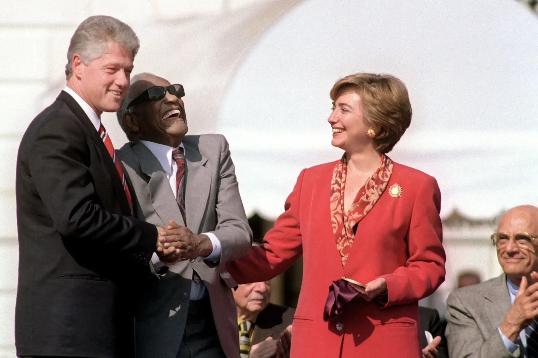 El músico y cantante de jazz estadounidense Ray Charles  posa con el presidente Bill Clinton, la primera dama Hillary Clinton y el dramaturgo Arthur Miller durante la ceremonia de entrega de la Medalla Nacional de las Artes el 7 de octubre de 1993 en la Casa Blanca.  AFP