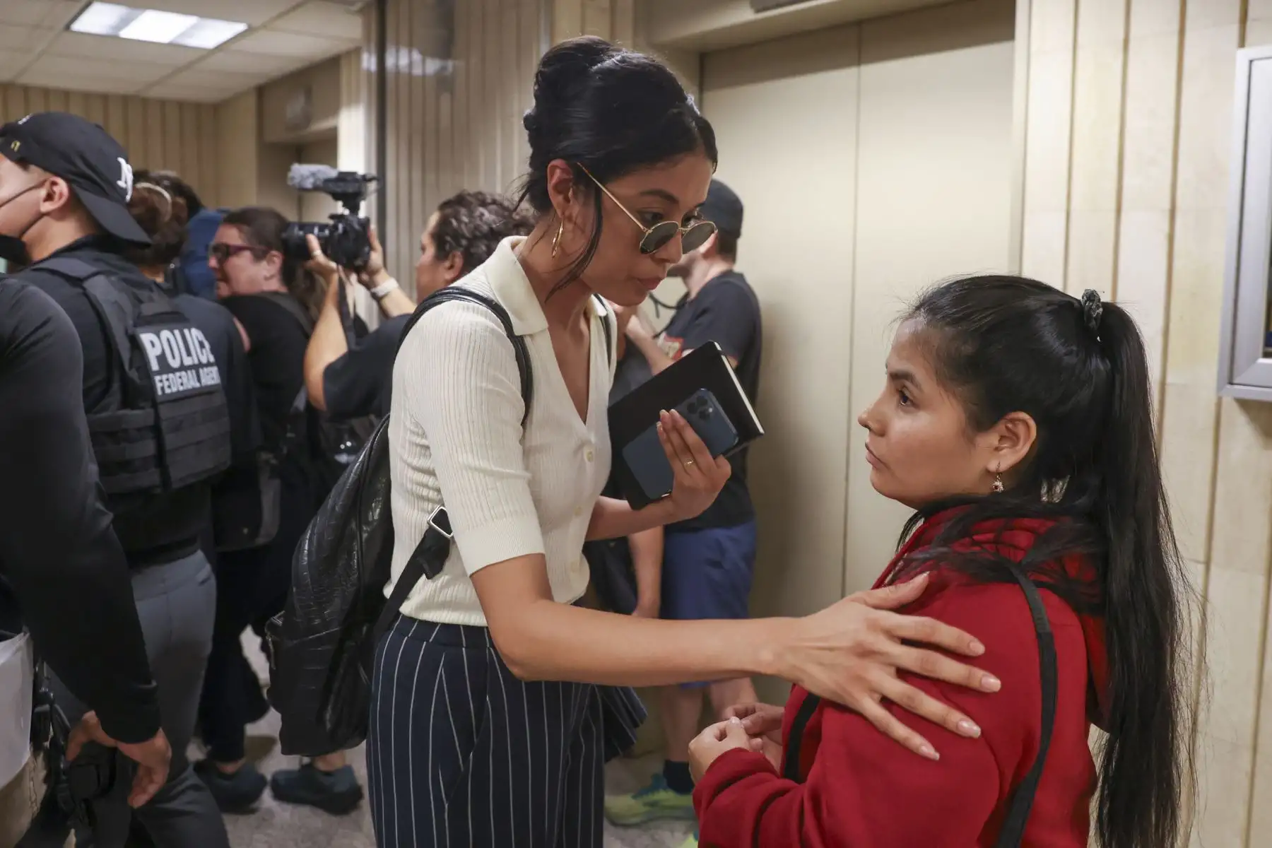 Una abogada asiste a una persona que acompañaba a un detenido después de que este asistiera a una audiencia en la corte de inmigración en el Edificio Federal Jacob K. Javits en Nueva York, EE.UU., el 11 de junio de 2025. El ICE ha aumentado su aplicación de medidas de seguridad tras los registros obligatorios en las audiencias. Foto: EFE