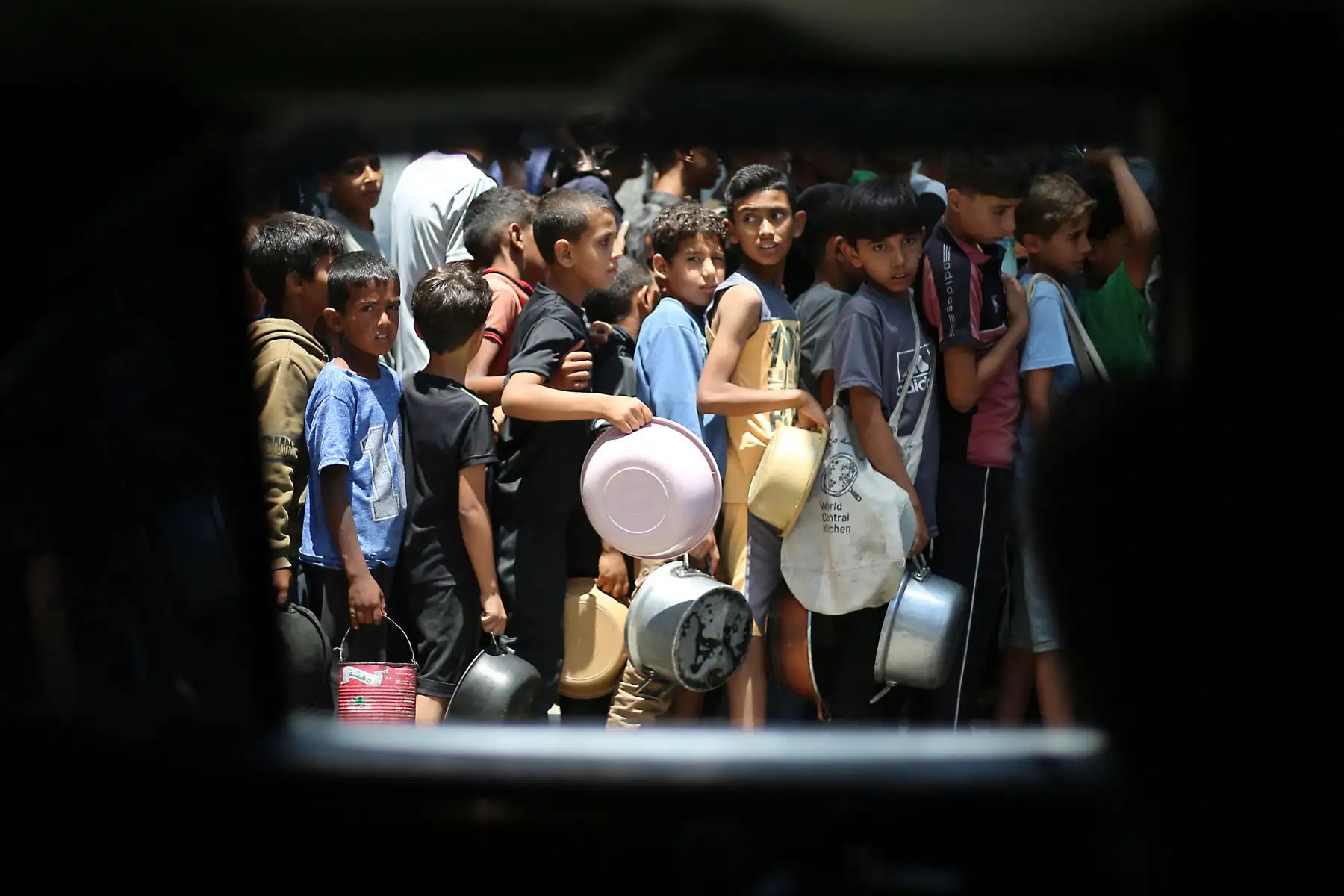Muchos niños pequeños esperan durante horas por comida y no llegan a conseguir llenar sus ollas en la repartición. Foto:AFP