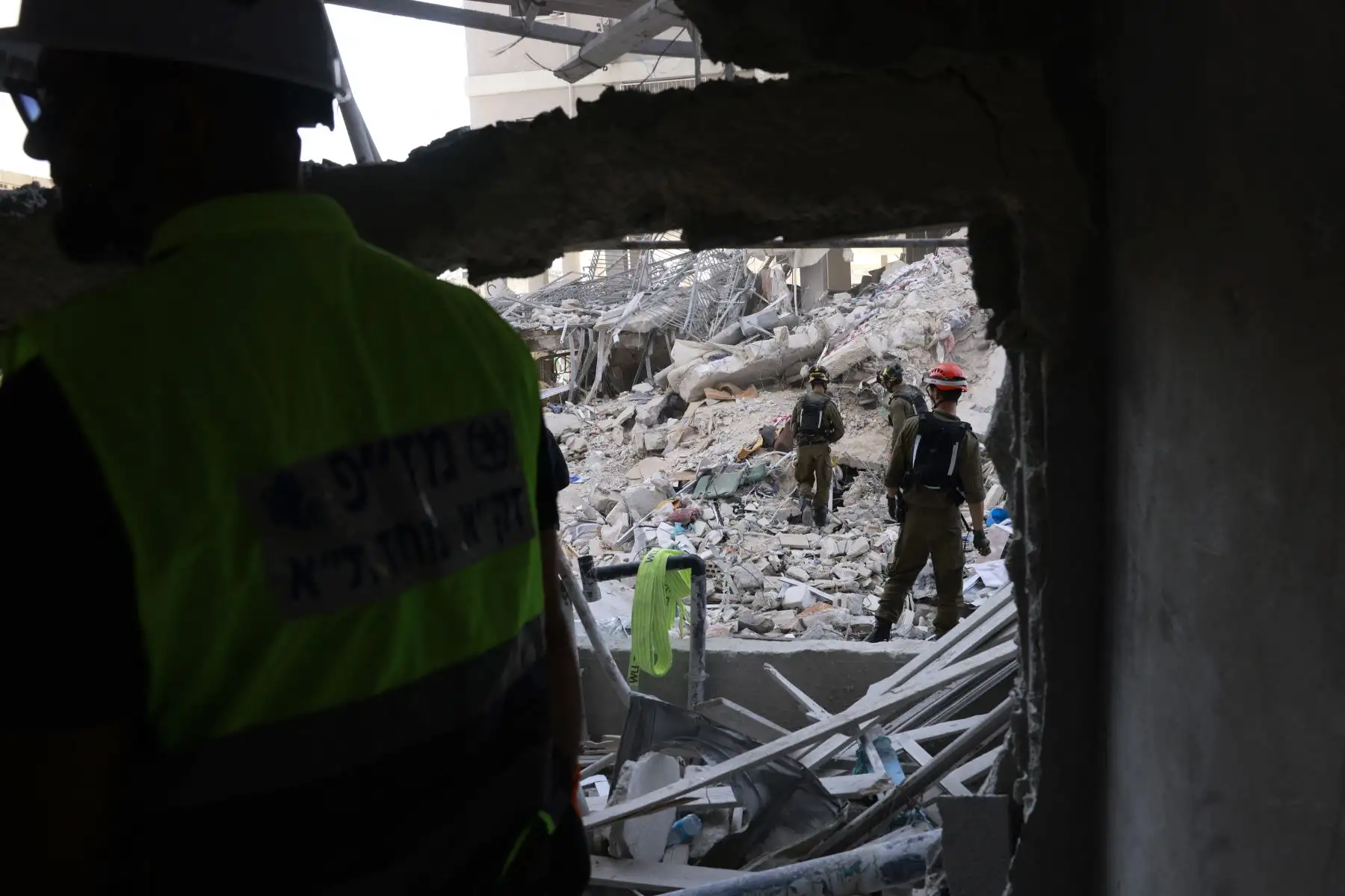 Rescatistas israelíes buscan entre los escombros en el lugar de un ataque con misiles iraníes durante la noche en Bat Yam el 15 de junio de 2025. 
Foto: AFP