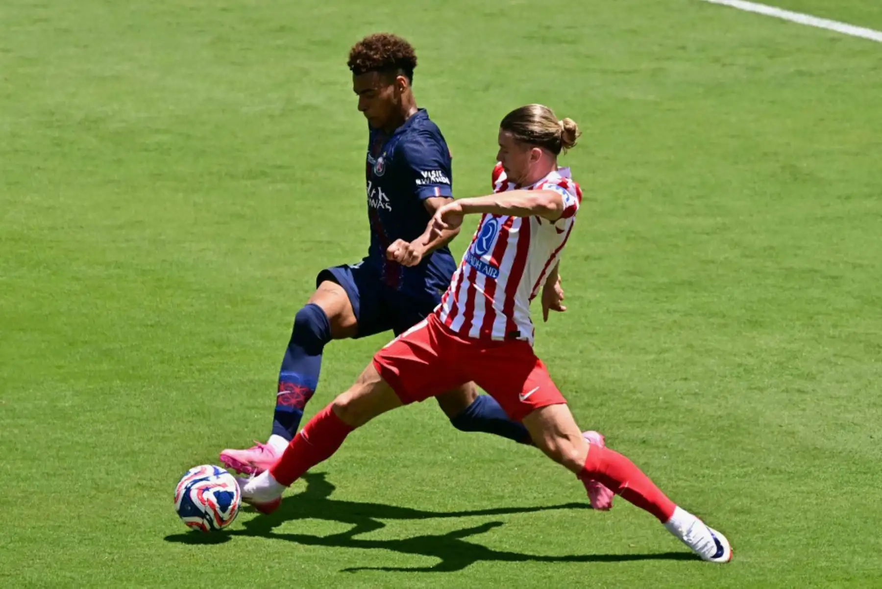 El centrocampista francés del Paris Saint-Germain, Desire Doue, lucha por el balón con el centrocampista inglés del Atlético de Madrid, Conor Gallagher, durante el partido de fútbol del Grupo B de la Copa Mundial de Clubes 2025 entre el Paris Saint-Germain de Francia y el Atlético de Madrid de España en el estadio Rose Bowl en Los Ángeles. Foto: AFP