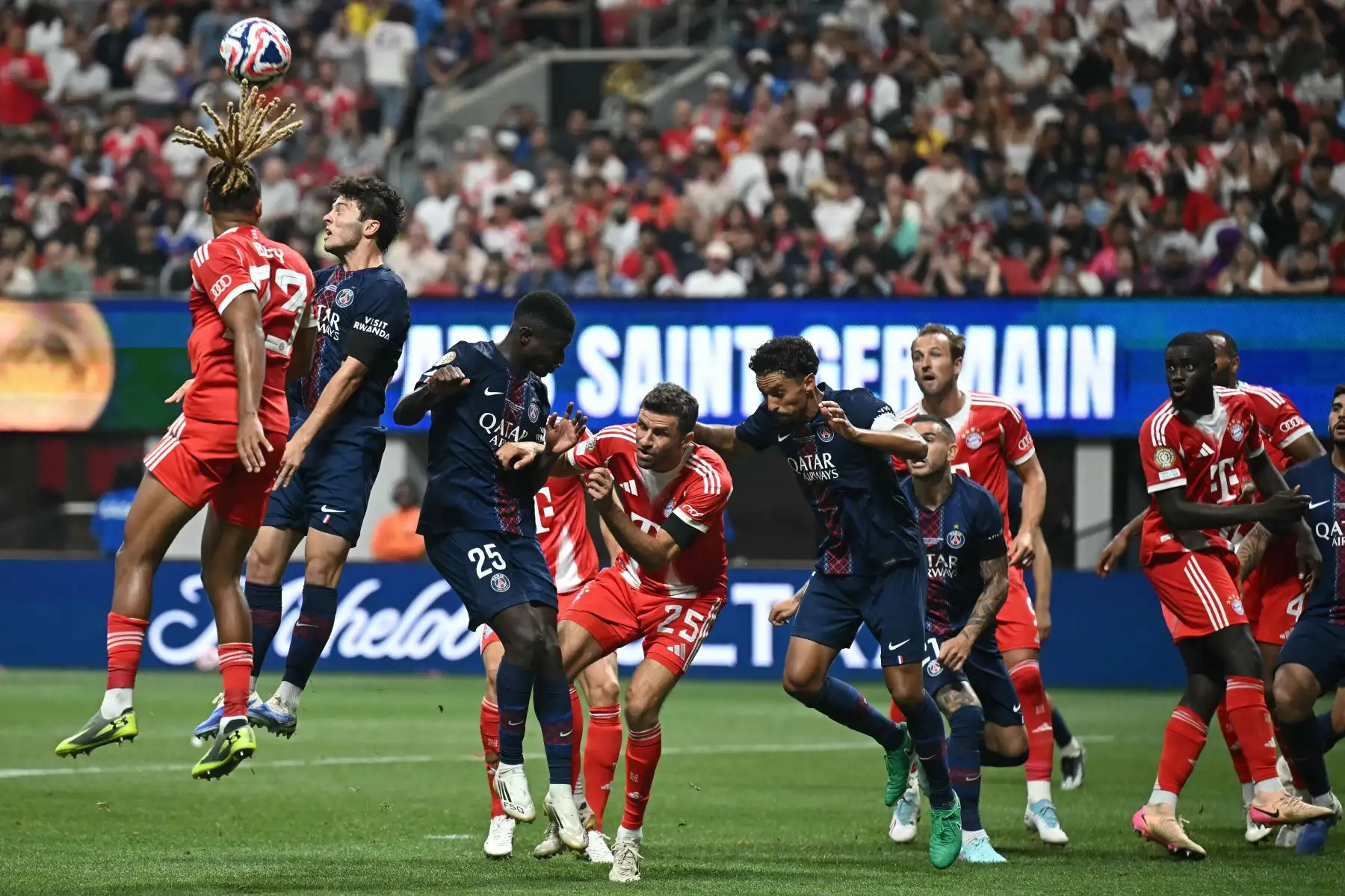 El defensa francés del Bayern Múnich, Sacha Boey, y el centrocampista portugués del Paris Saint-Germain, Joao Pedro Goncalves Neves, saltan para cabecear el balón durante el partido de cuartos de final de la Copa Mundial de Clubes de la FIFA 2025 entre el Paris Saint-Germain de Francia y el Bayern Múnich de Alemania. 
Foto: ANDINA/AFP
