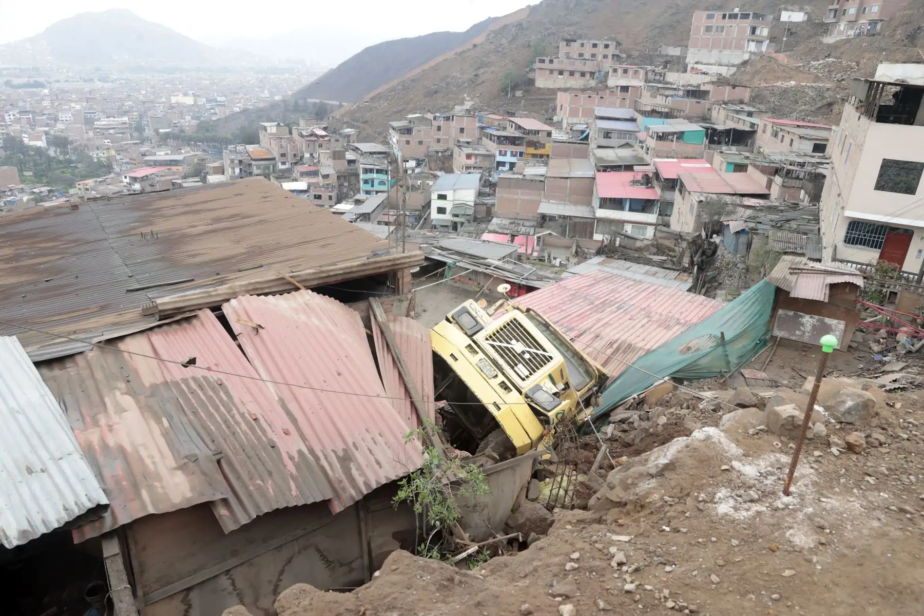 Un camión cayó aparatosamente desde una altura en la zona de Las Terrazas de Catalina Huanca, en el distrito de El Agustino. El vehículo impactó contra dos viviendas. Foto: ANDINA/Vidal Tarqui