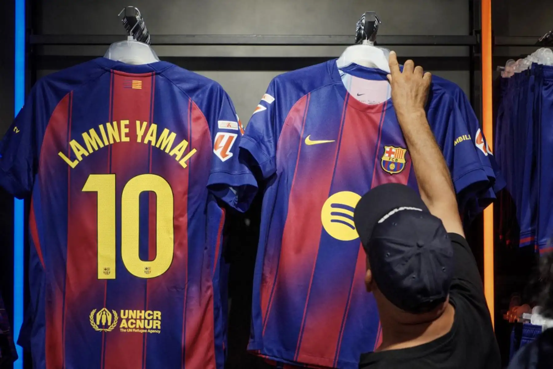 La gente compra la nueva camiseta número 10 del delantero español del Barcelona, Lamine Yamal, en la tienda oficial del FCB en Barcelona. Foto: AFP