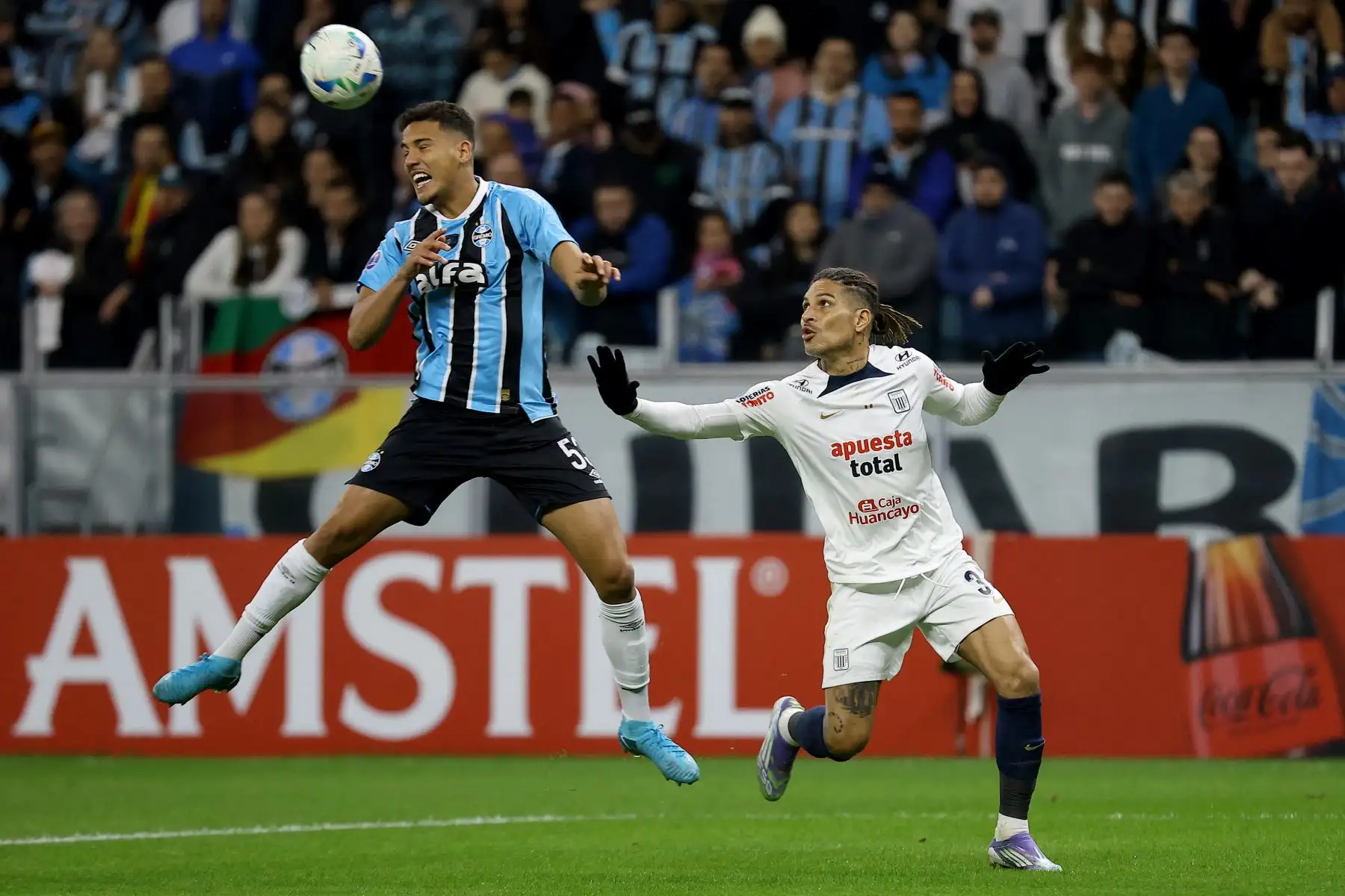 El defensa  de Gremio, Gustavo Martins, y el delantero de Alianza Lima, Paolo Guerrero, disputan el balón durante el partido de eliminatoria de la Copa Sudamericana entre Gremio de Brasil y Alianza Lima de Perú en el estadio Arena do Gremio en Porto Alegre. 
Foto: ANDINA/ AFP